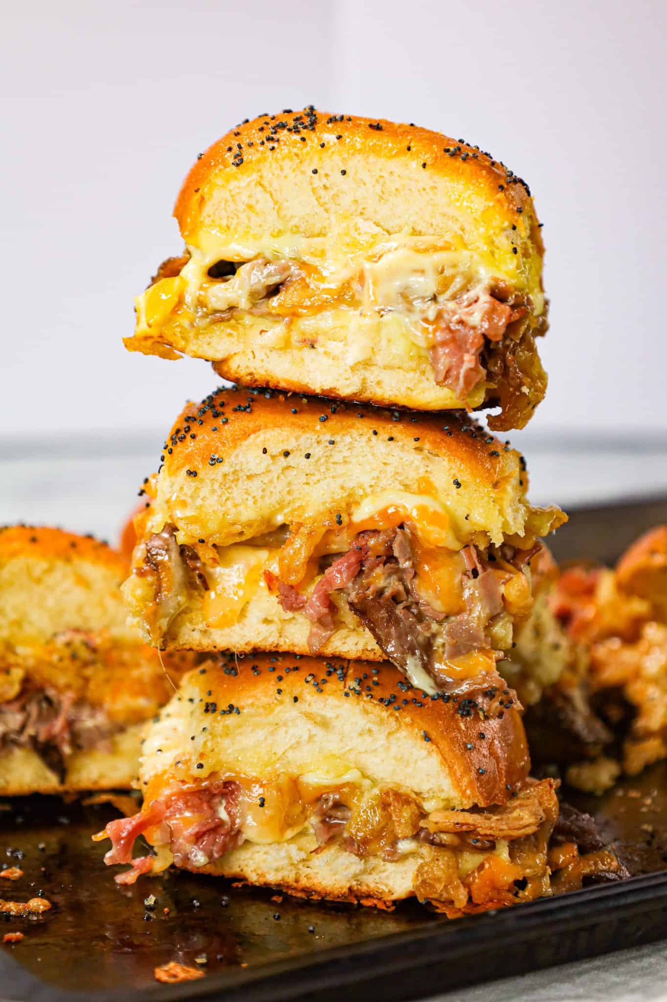 Roast Beef Sliders are an easy dinner or party snack made with dinner rolls and loaded with deli shaved roast beef, mayo, horseradish, mozzarella, cheddar and crispy fried onions.