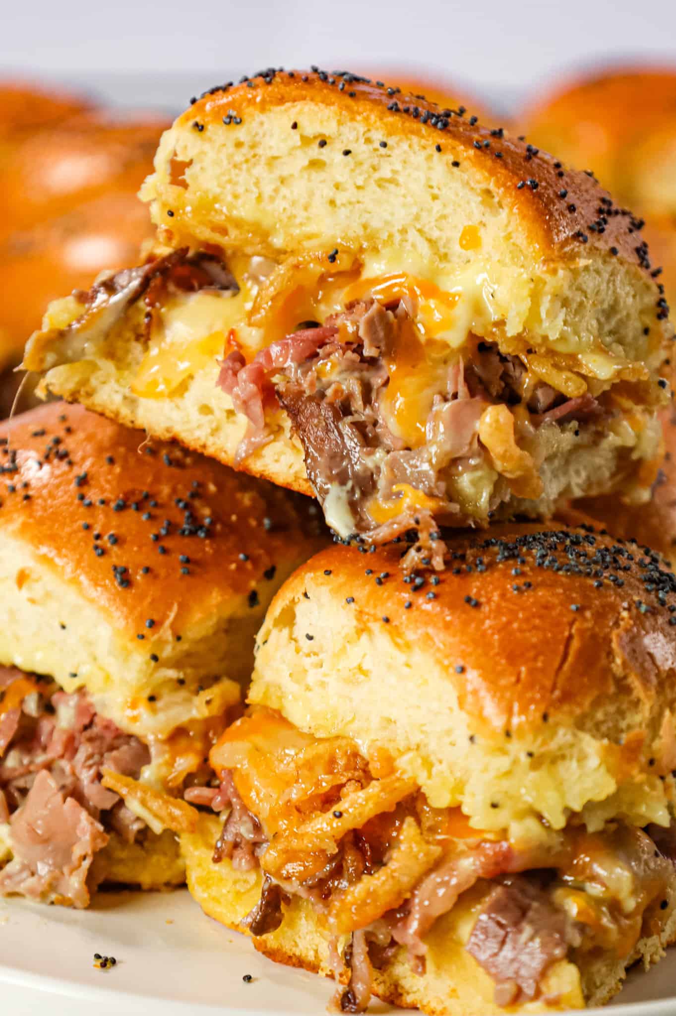 Roast Beef Sliders are an easy dinner or party snack made with dinner rolls and loaded with deli shaved roast beef, mayo, horseradish, mozzarella, cheddar and crispy fried onions.