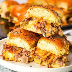 Roast Beef Sliders are an easy dinner or party snack made with dinner rolls and loaded with deli shaved roast beef, mayo, horseradish, mozzarella, cheddar and crispy fried onions.