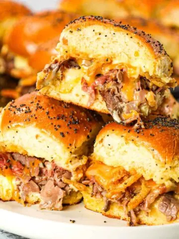 Roast Beef Sliders are an easy dinner or party snack made with dinner rolls and loaded with deli shaved roast beef, mayo, horseradish, mozzarella, cheddar and crispy fried onions.