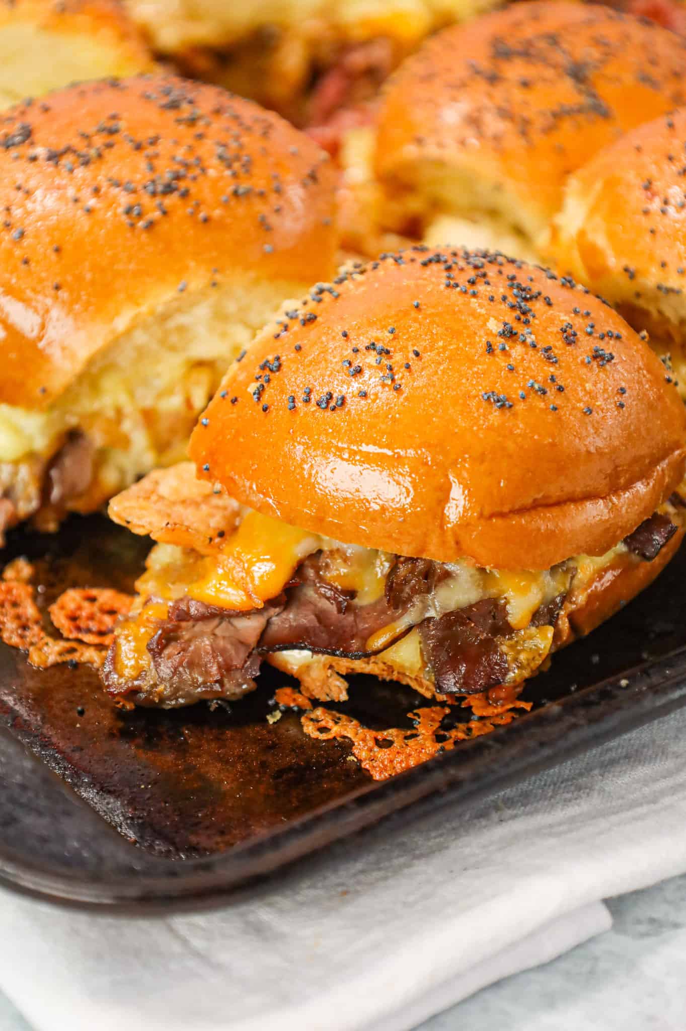 Roast Beef Sliders are an easy dinner or party snack made with dinner rolls and loaded with deli shaved roast beef, mayo, horseradish, mozzarella, cheddar and crispy fried onions.