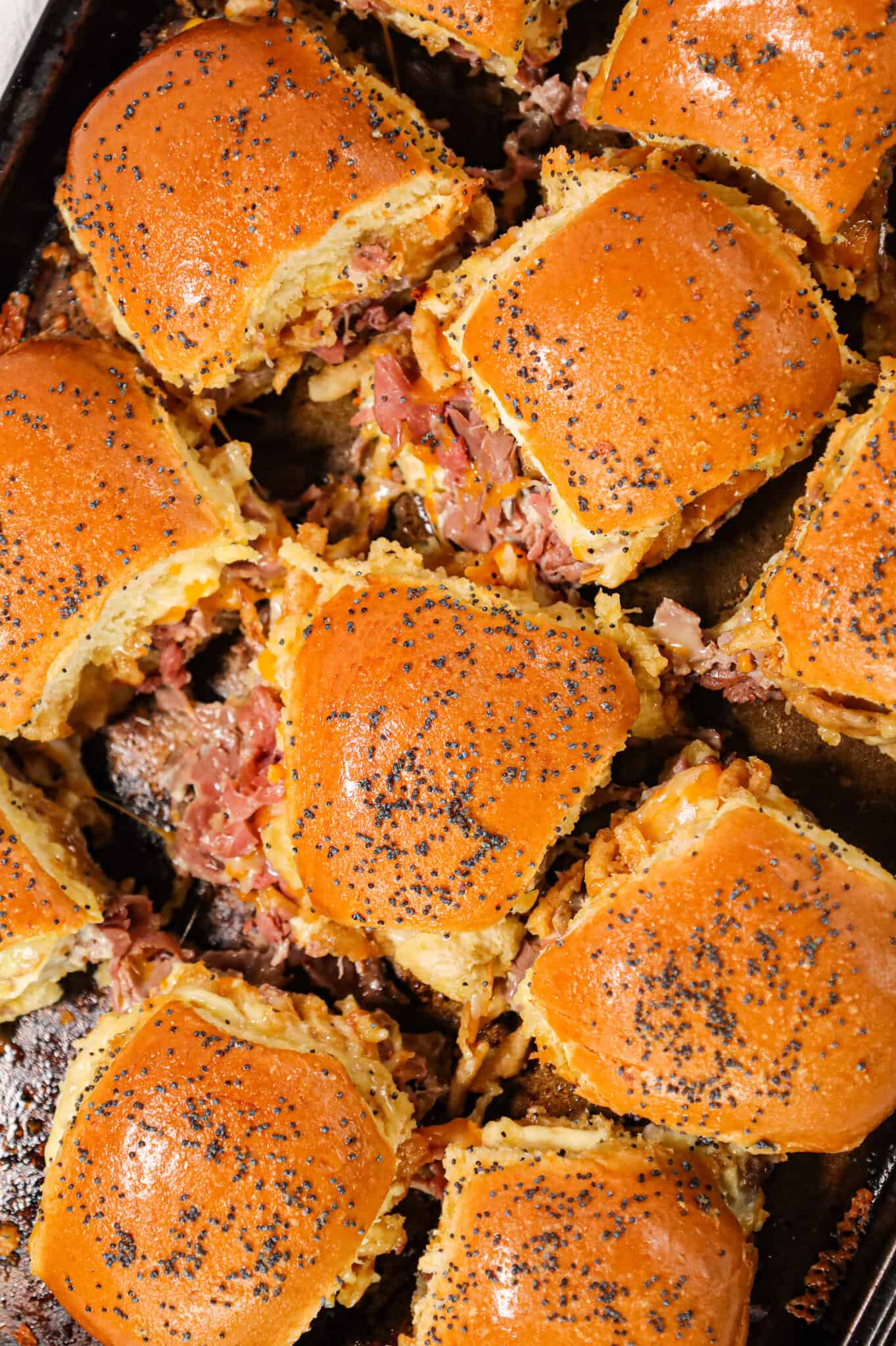 Roast Beef Sliders are an easy dinner or party snack made with dinner rolls and loaded with deli shaved roast beef, mayo, horseradish, mozzarella, cheddar and crispy fried onions.