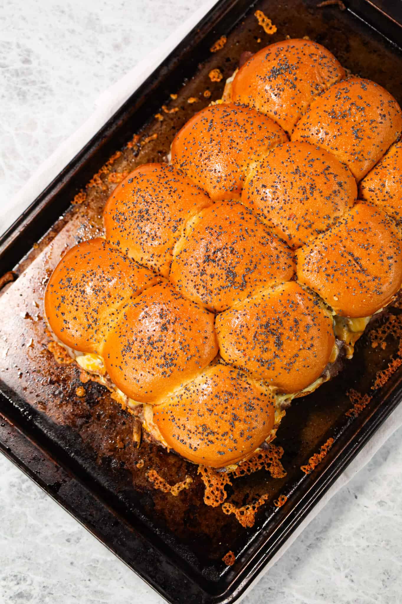 Roast Beef Sliders are an easy dinner or party snack made with dinner rolls and loaded with deli shaved roast beef, mayo, horseradish, mozzarella, cheddar and crispy fried onions.