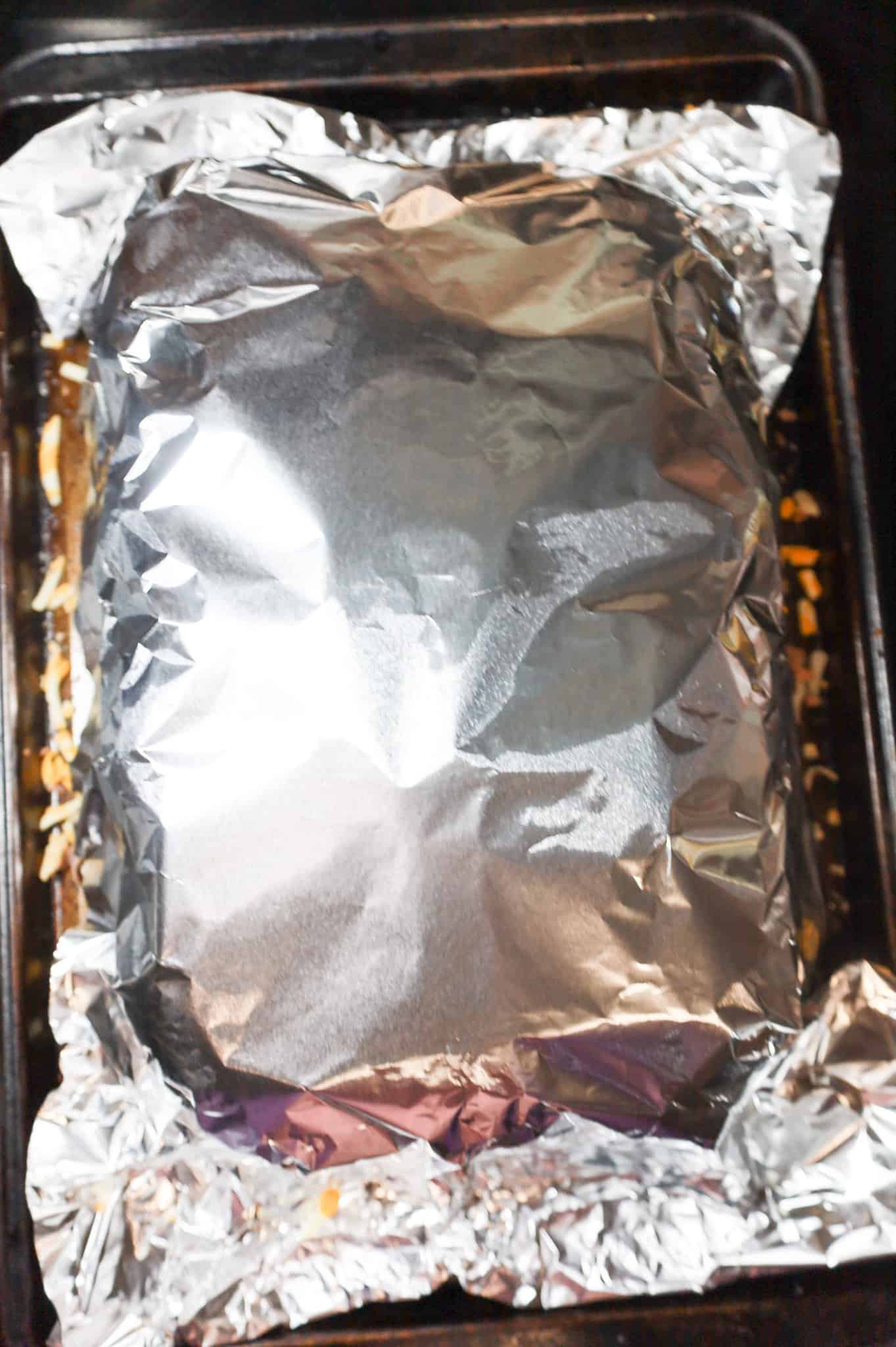 foil covering sliders on a baking sheet