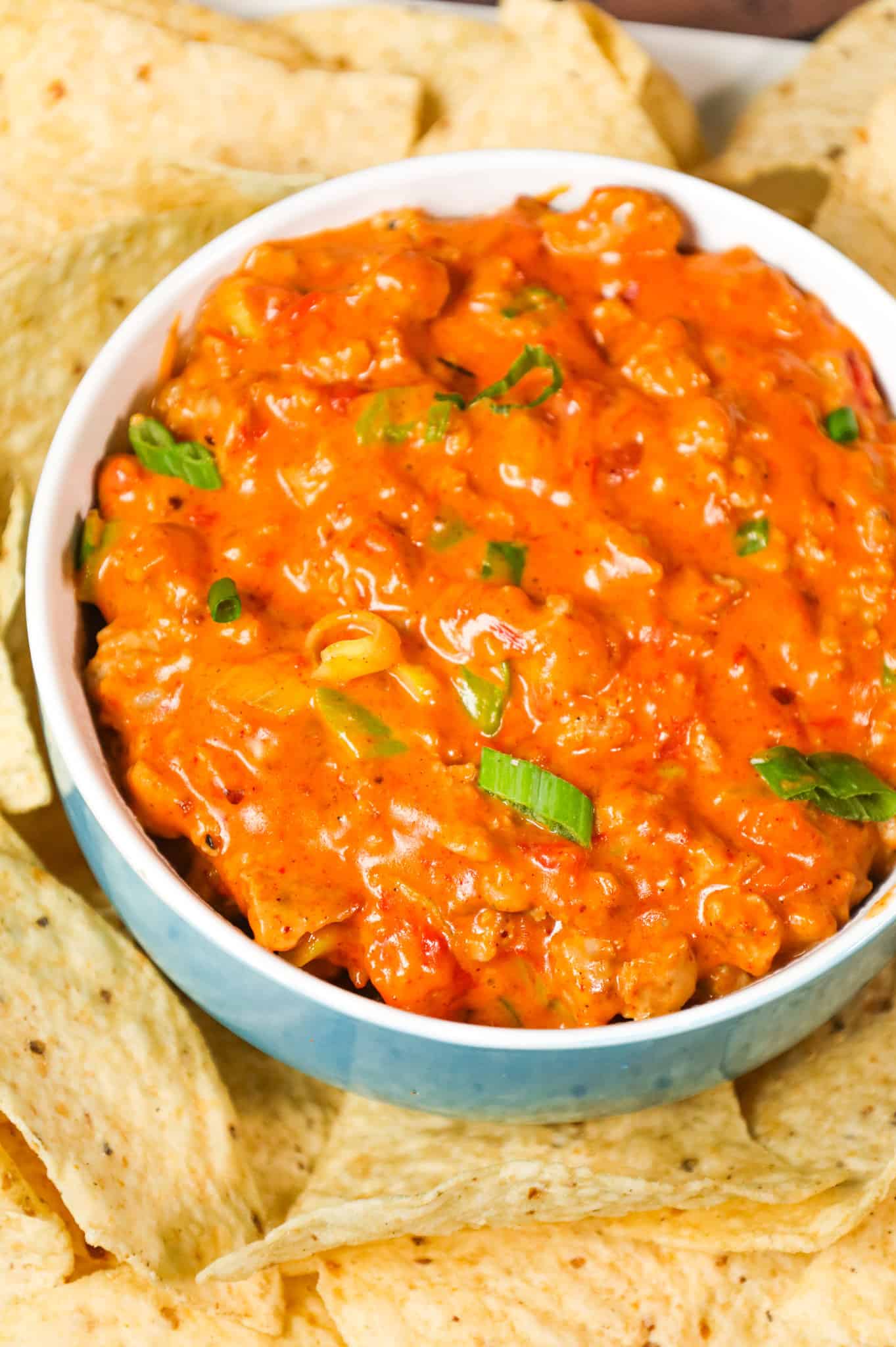Rotel Dip is a cheesy dip made with Velveeta and loaded with ground sausage, Rotel diced tomatoes and green chilies, taco seasoning and chopped green onions.