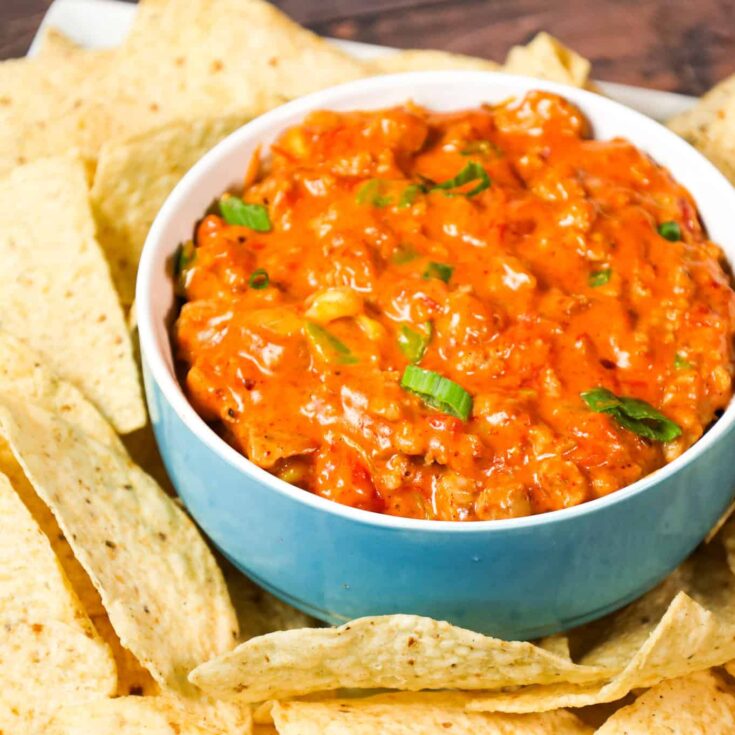 Rotel Dip is a cheesy dip made with Velveeta and loaded with ground sausage, Rotel diced tomatoes and green chilies, taco seasoning and chopped green onions.