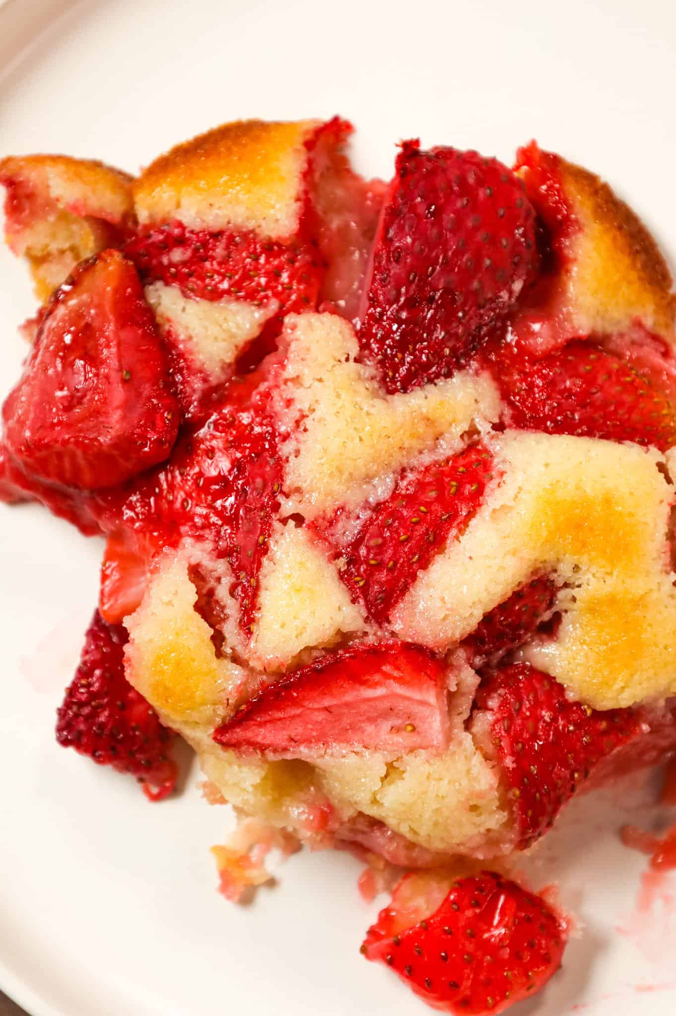 Strawberry Cobbler is an easy and delicious dessert recipe made with fresh strawberries baked in a delicious vanilla cake like batter.
