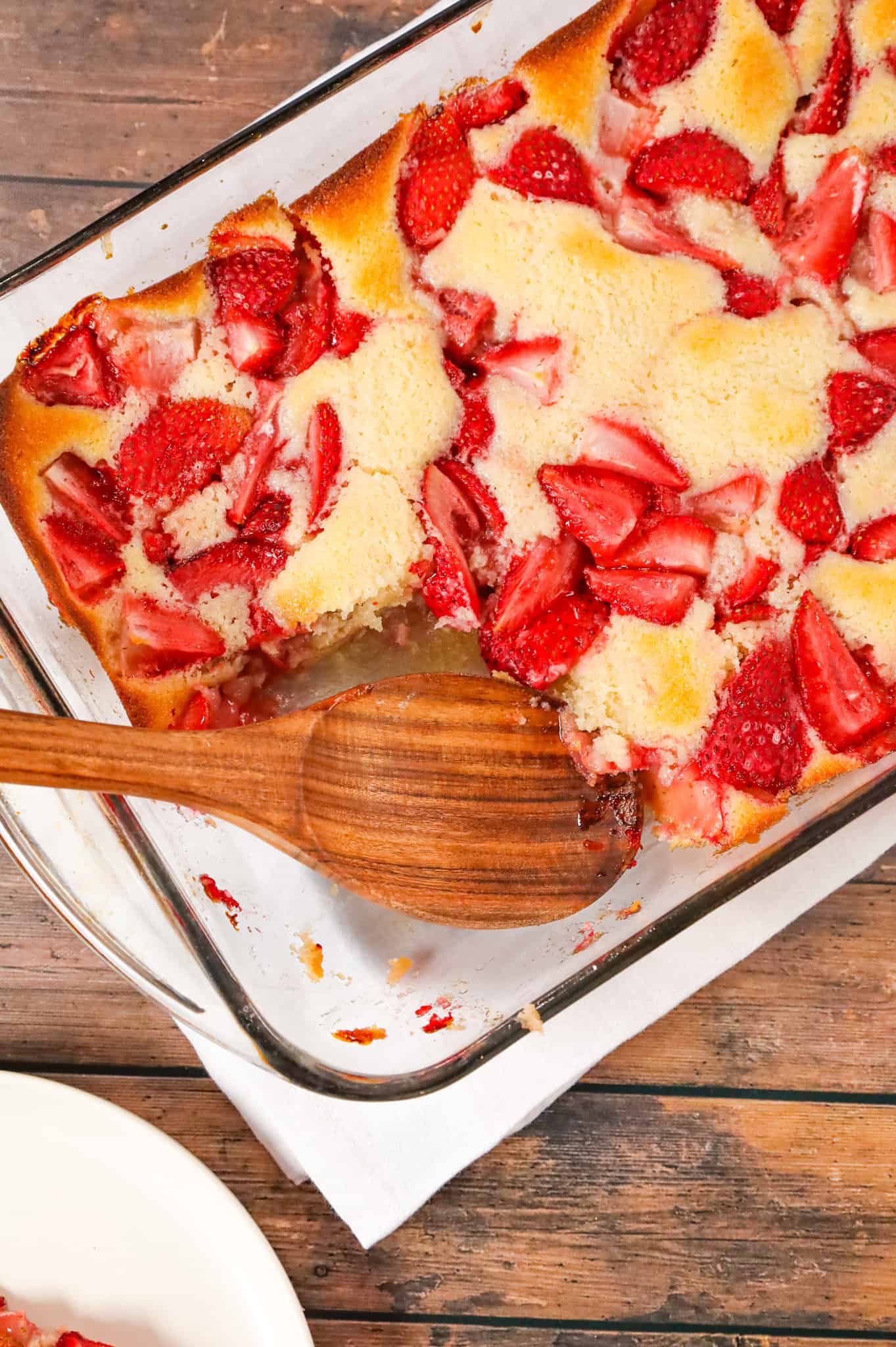 Strawberry Cobbler is an easy and delicious dessert recipe made with fresh strawberries baked in a delicious vanilla cake like batter.