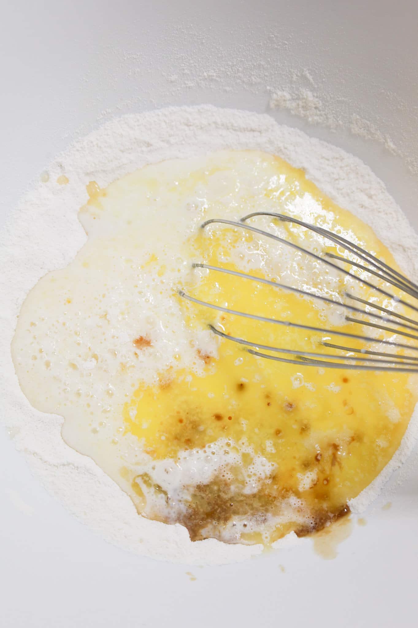 milk, melted butter and vanilla extract on top of dry ingredients in a mixing bowl
