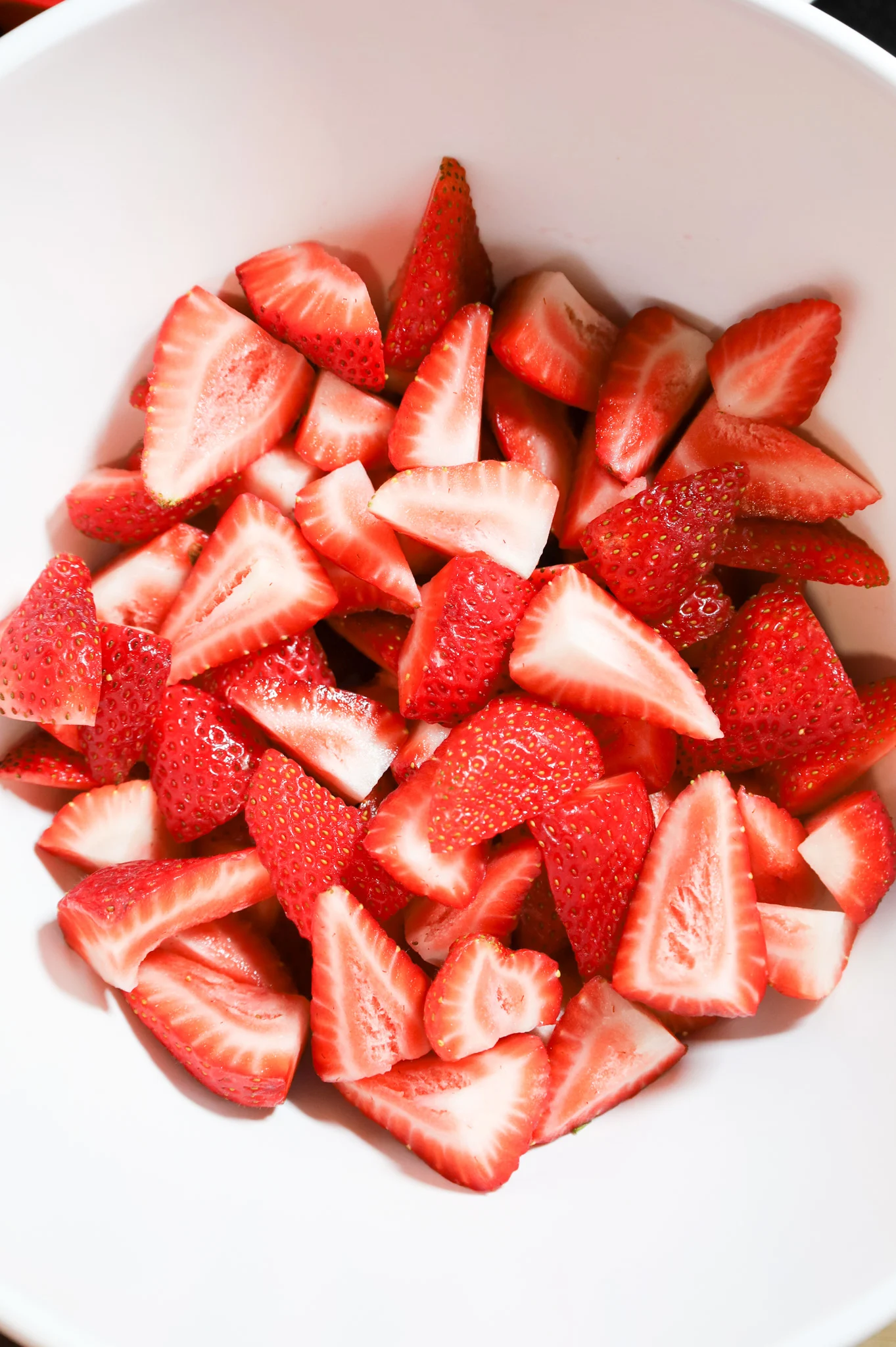 quartered strawberries in a mixing bowl