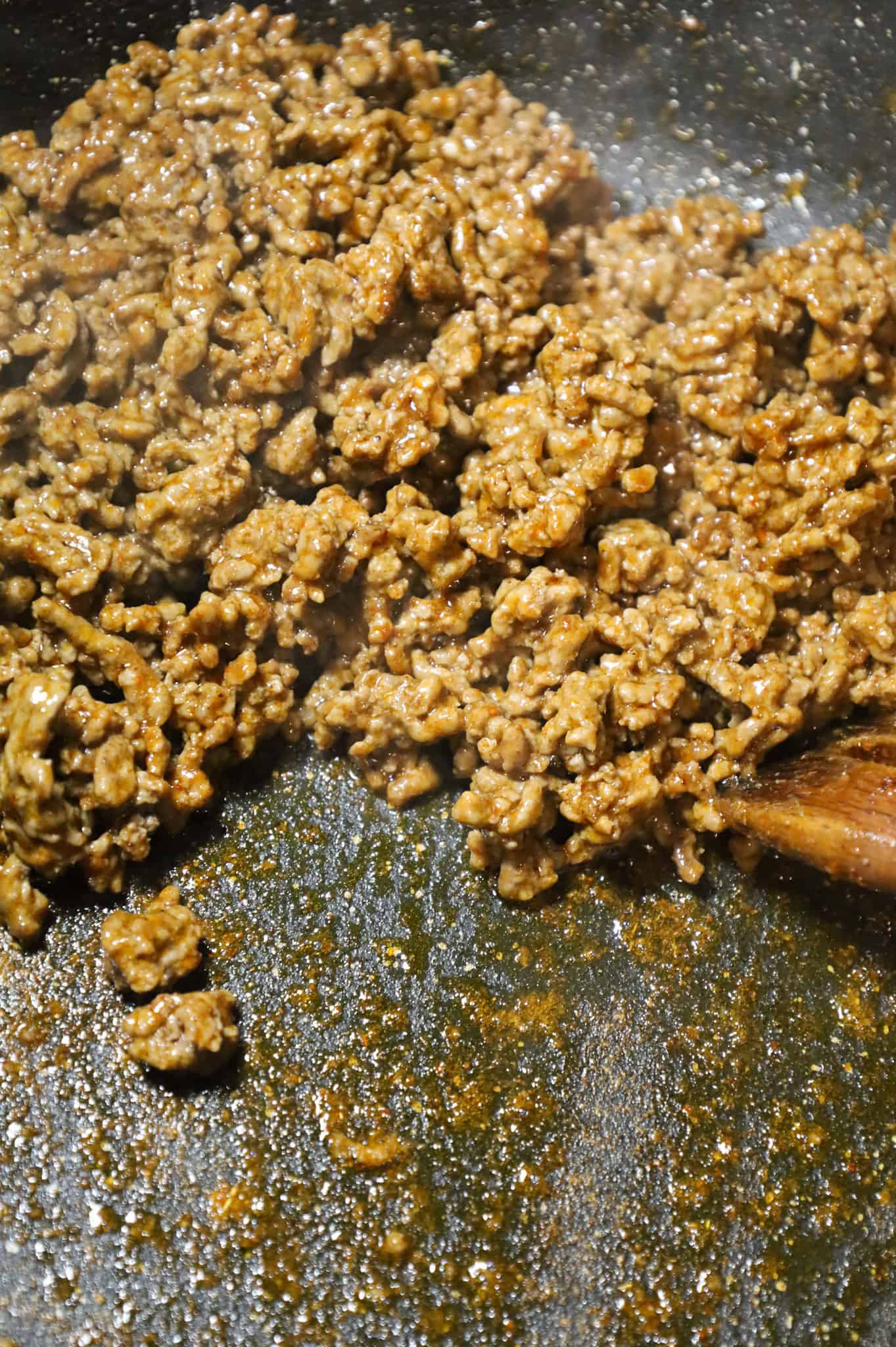 cooked ground beef coated in a taco seasoning in a skillet