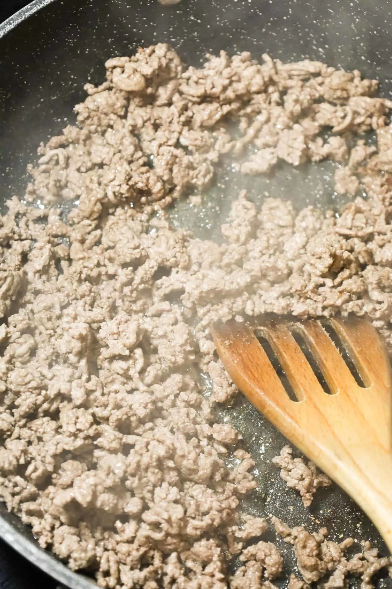 crumbled ground beef browning in a skillet