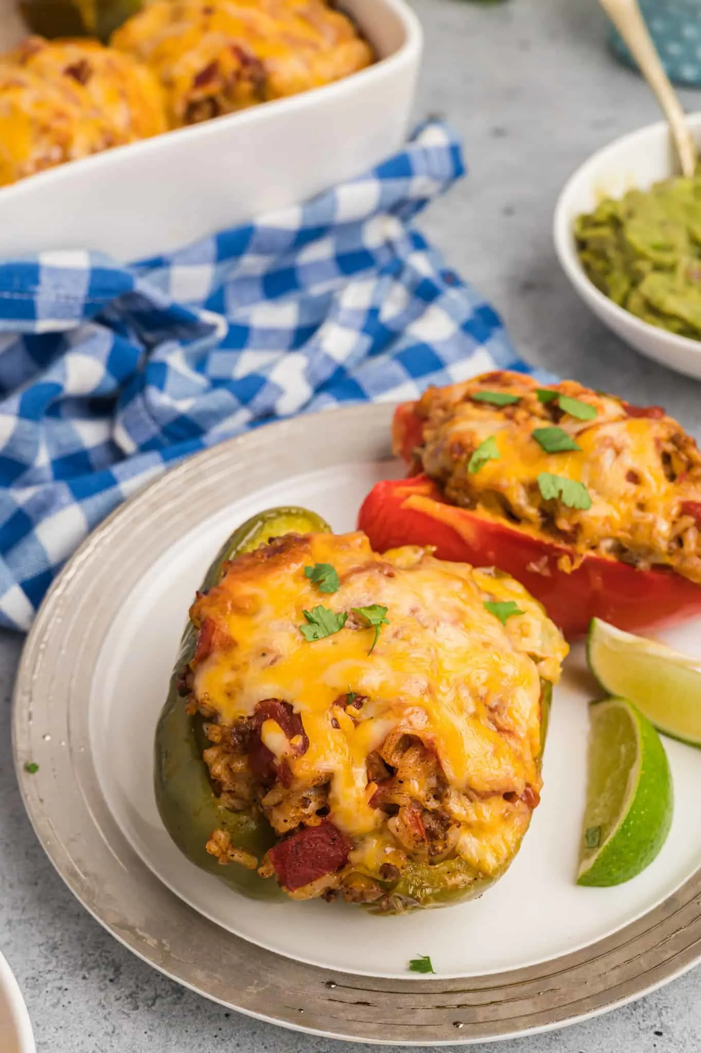 Taco Stuffed Peppers are an easy weeknight dinner recipe made with bell peppers stuffed with a ground beef, rice and taco sauce mixture and baked with cheese on top.