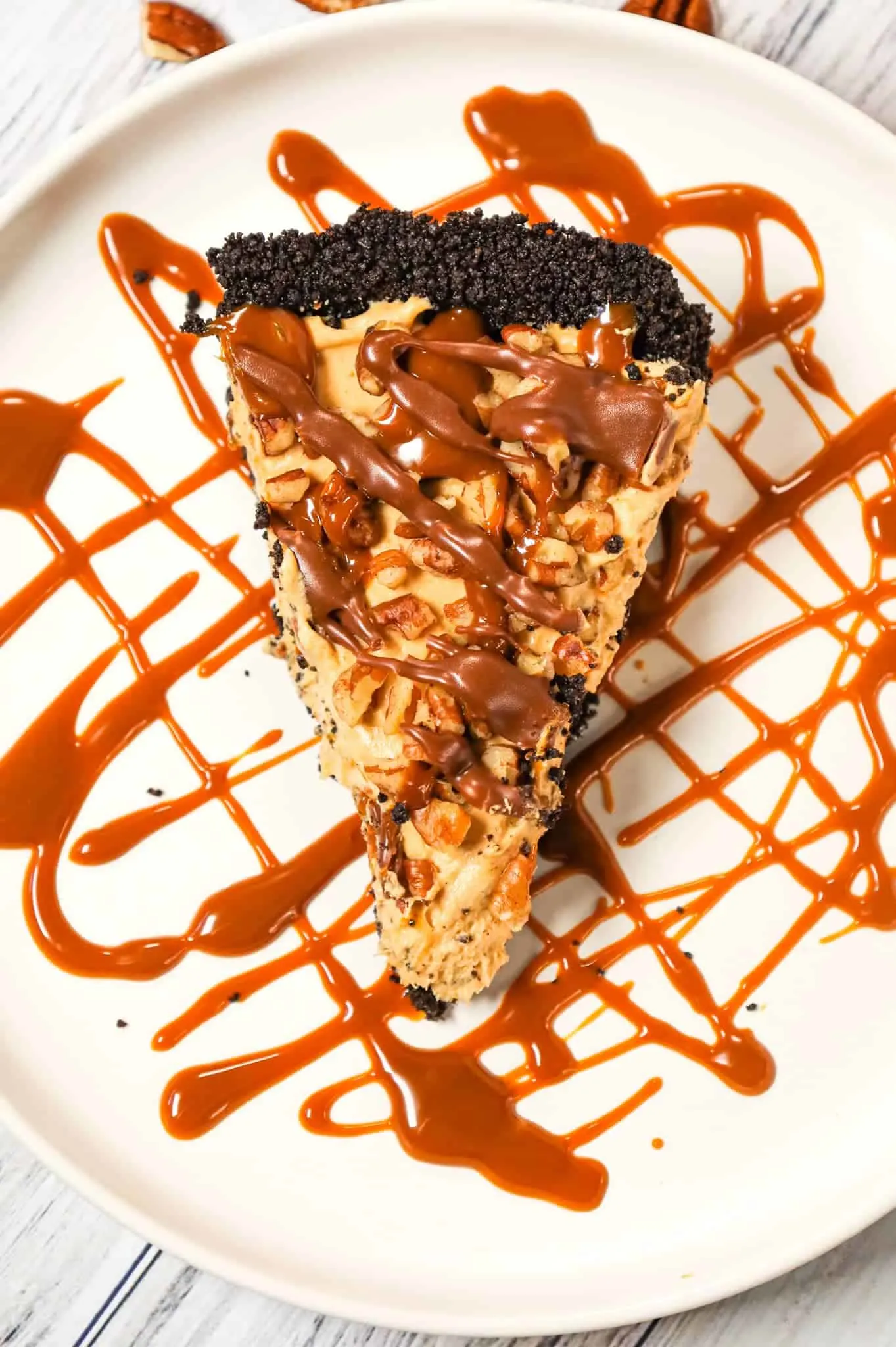 Turtle Pie is a delicious no bake cheesecake pie in an Oreo crust and loaded with caramel sauce, milk chocolate and chopped pecans.
