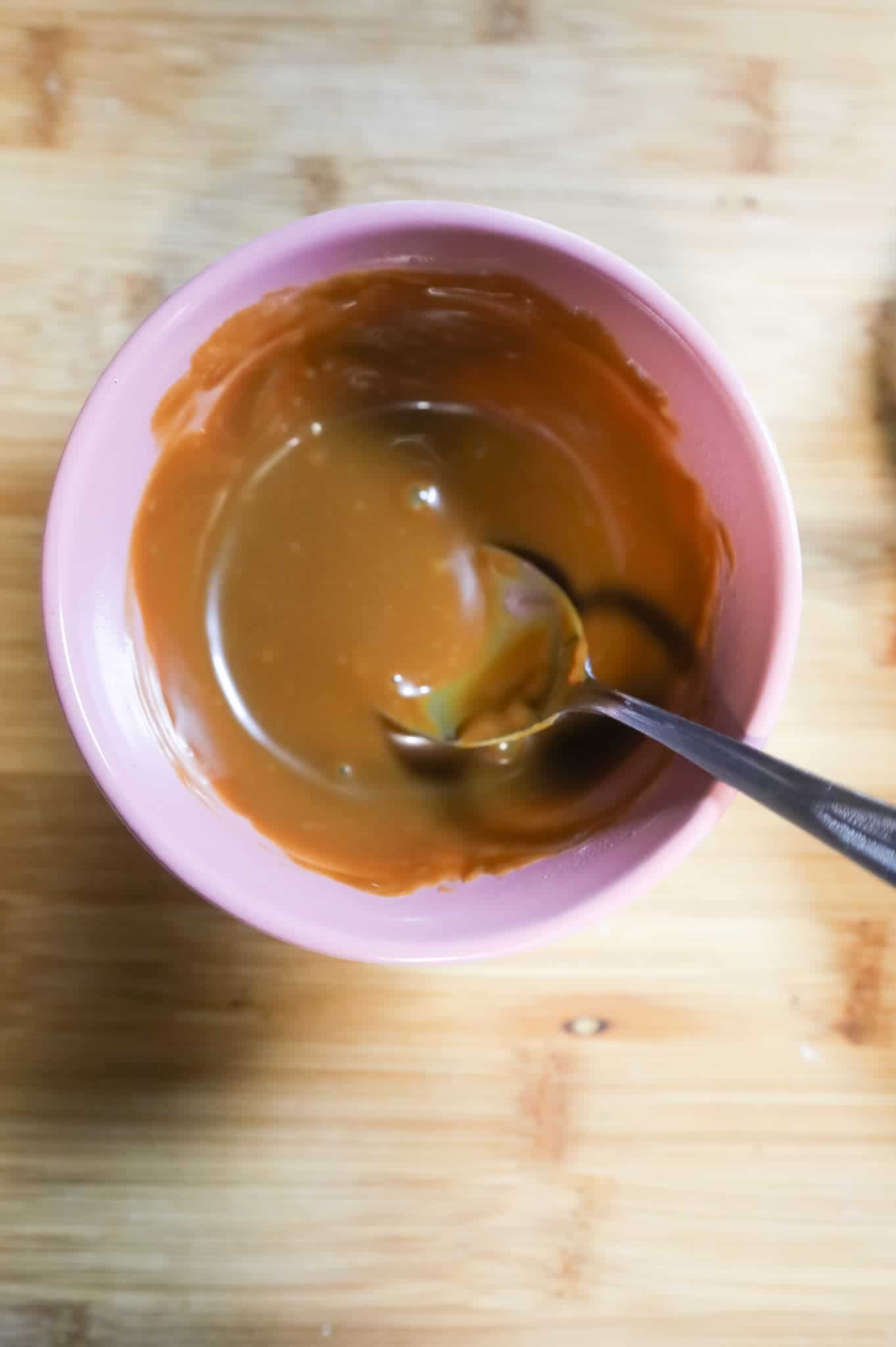 melted dulce de leche in a small bowl