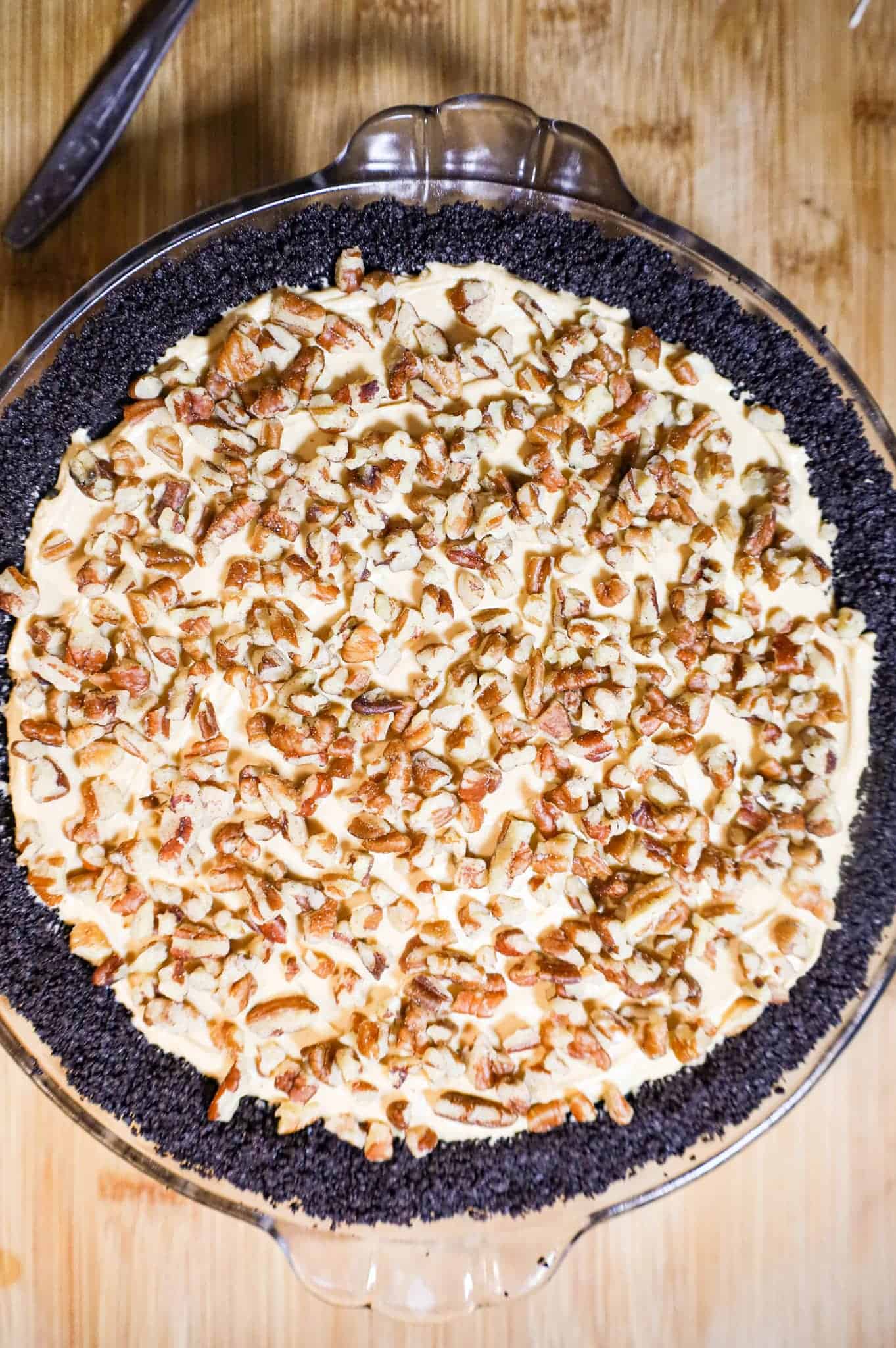 caramel pecan cheesecake in an Oreo pie crust