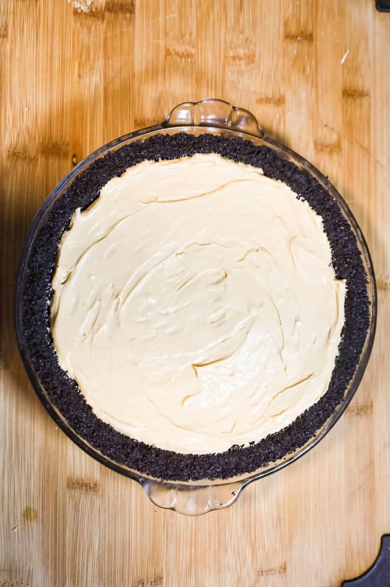 caramel cheesecake mixture in an oreo pie crust