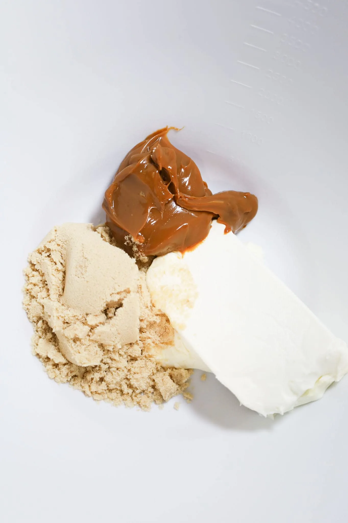 dulce de leche, brown sugar and softened cream cheese in a mixing bowl
