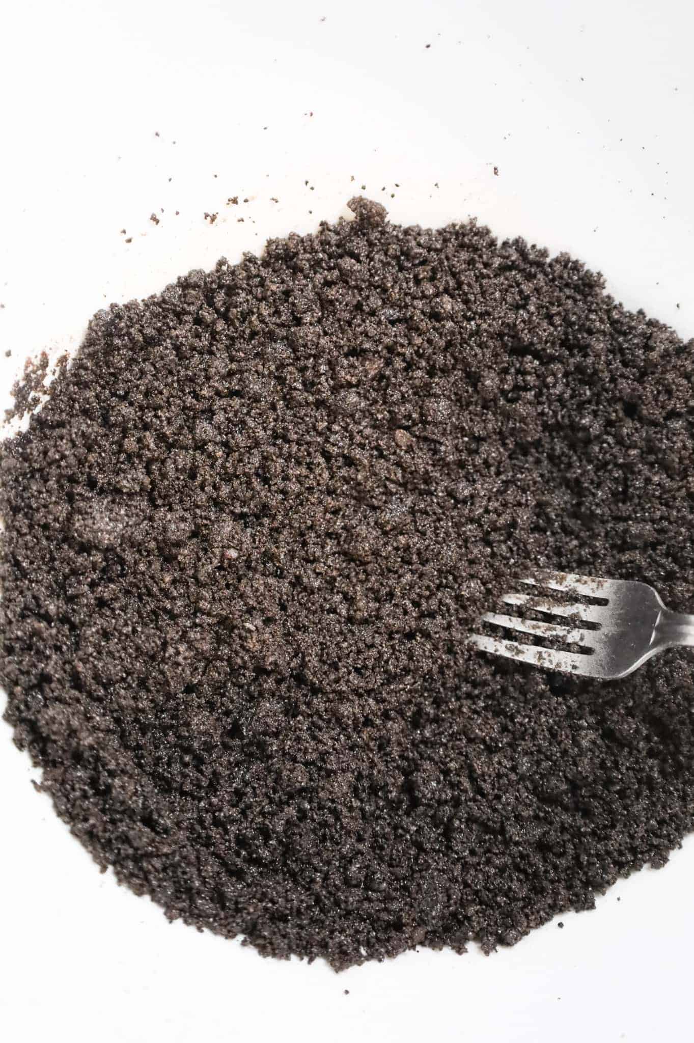 oreo crumb and melted butter mixture in a mixing bowl