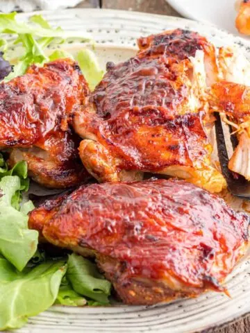 Air Fryer BBQ Chicken Thighs are juicy seasoned chicken thighs brushed with your favourite BBQ sauce that can be ready in under half an hour.