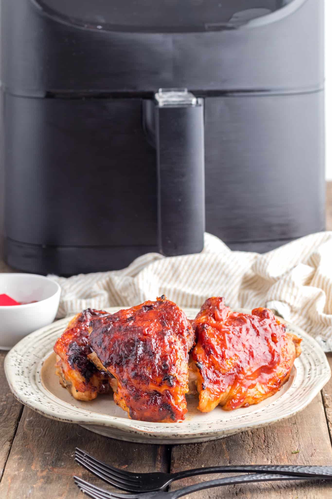 Air Fryer BBQ Chicken Thighs are juicy seasoned chicken thighs brushed with your favourite BBQ sauce that can be ready in under half an hour.