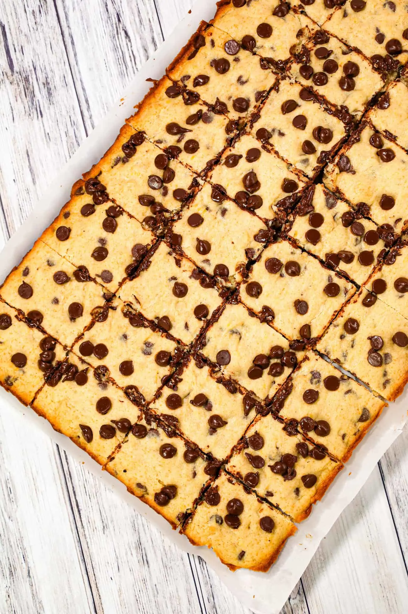 Banana Chocolate Chip Bars are an easy dessert recipe made with ripe bananas and loaded with semi sweet chocolate chips.