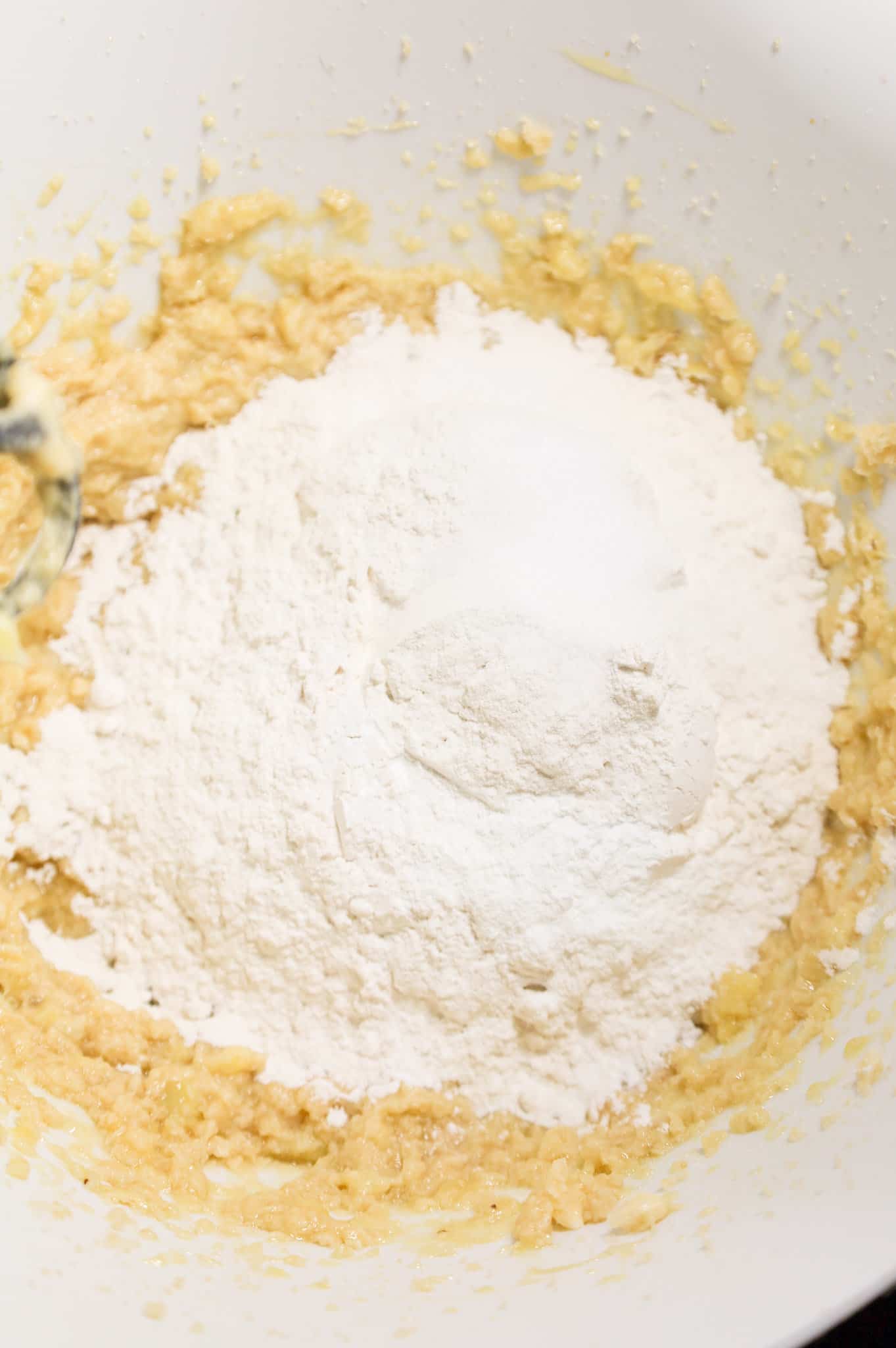 flour added to bowl with banana batter mixture
