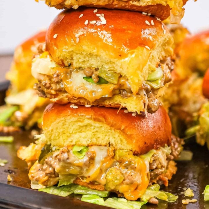 Big Mac Sliders are an easy weeknight dinner recipe made with ground beef, onion, pickles, mayo, Thousand Island dressing, cheddar cheese and shredded lettuce all piled on to dinner rolls topped with sesame seeds.