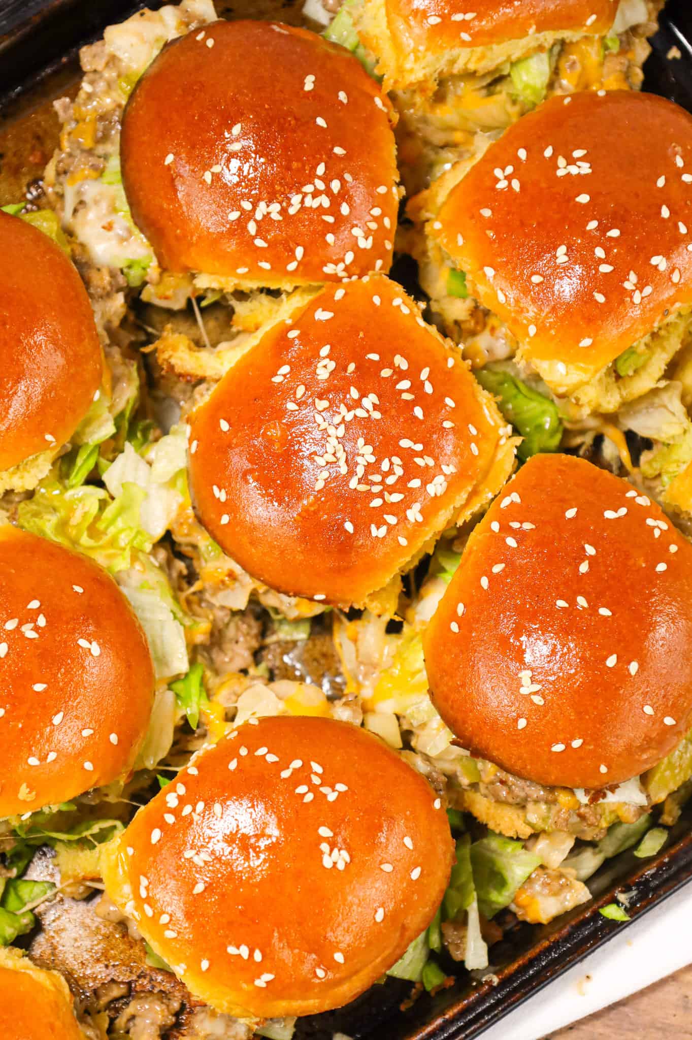 Big Mac Sliders are an easy weeknight dinner recipe made with ground beef, onion, pickles, mayo, Thousand Island dressing, cheddar cheese and shredded lettuce all piled on to dinner rolls topped with sesame seeds.