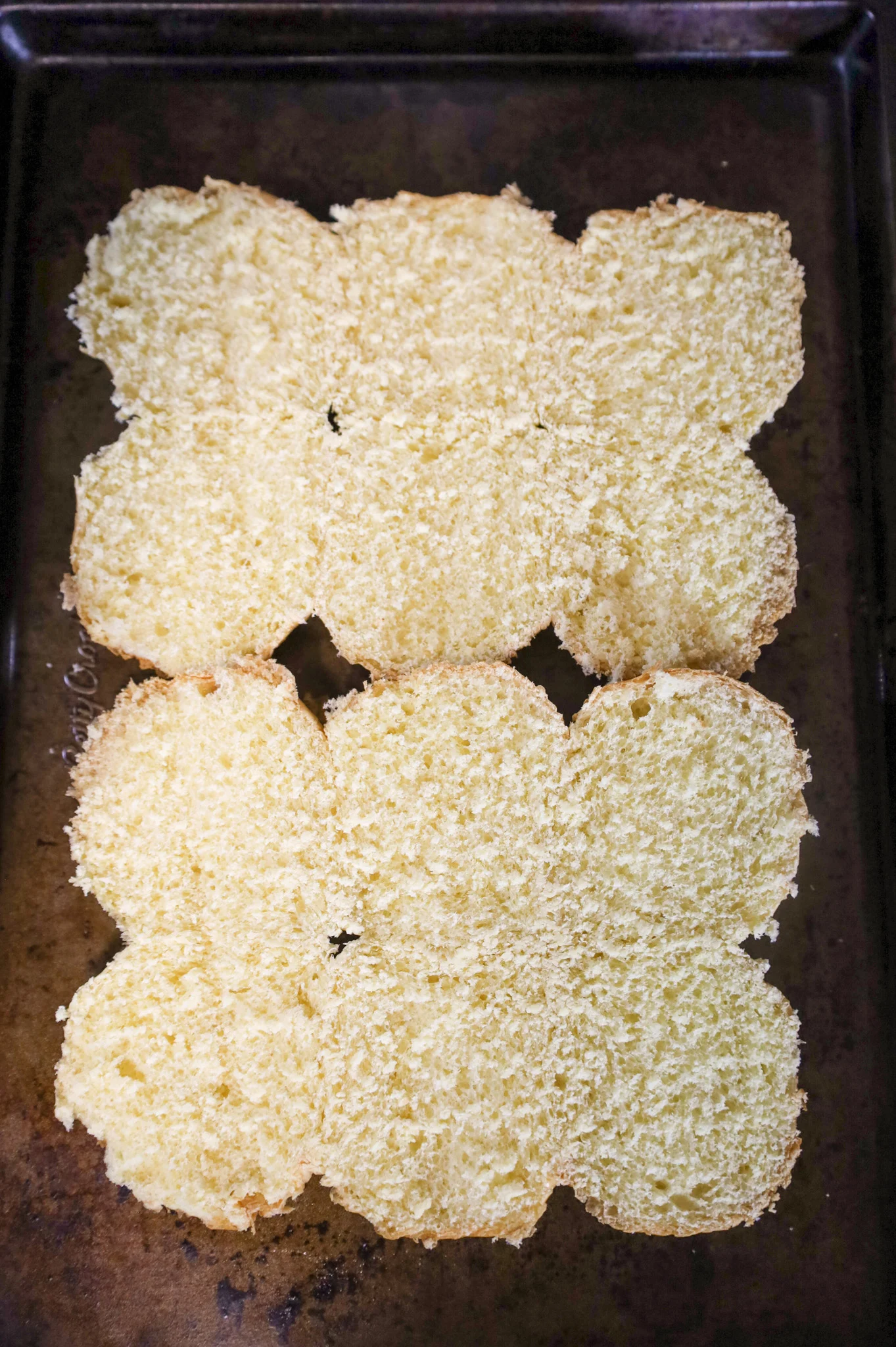bottom slider buns on a baking sheet