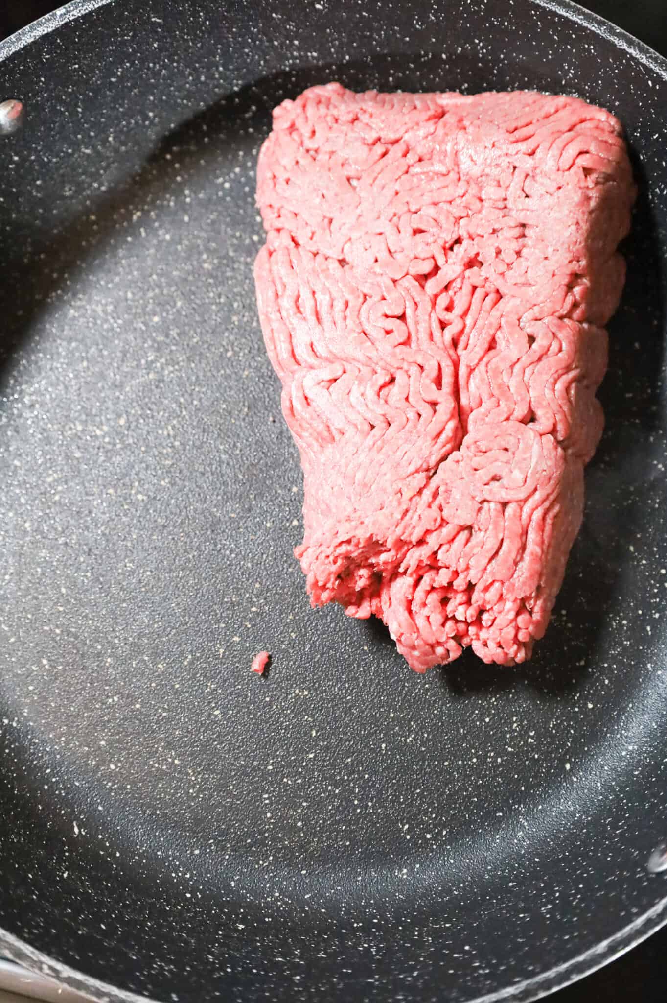 raw ground beef in a skillet