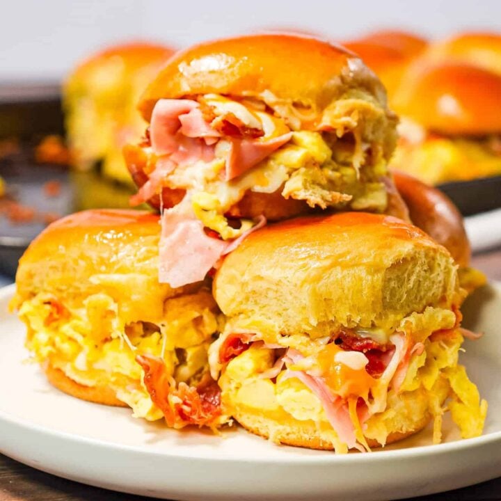 Breakfast Sliders are small pull apart breakfast sandwiches loaded with scrambled eggs, ham, bacon and cheese.