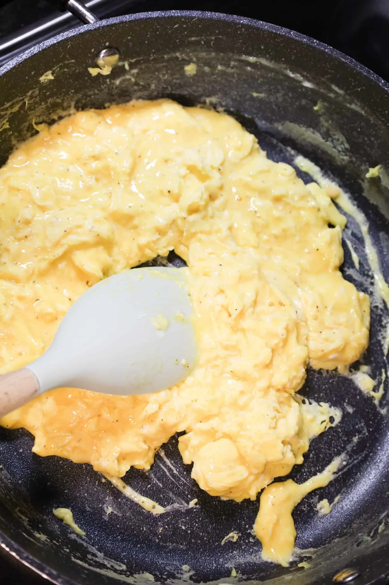 scrambled eggs cooking in a skillet