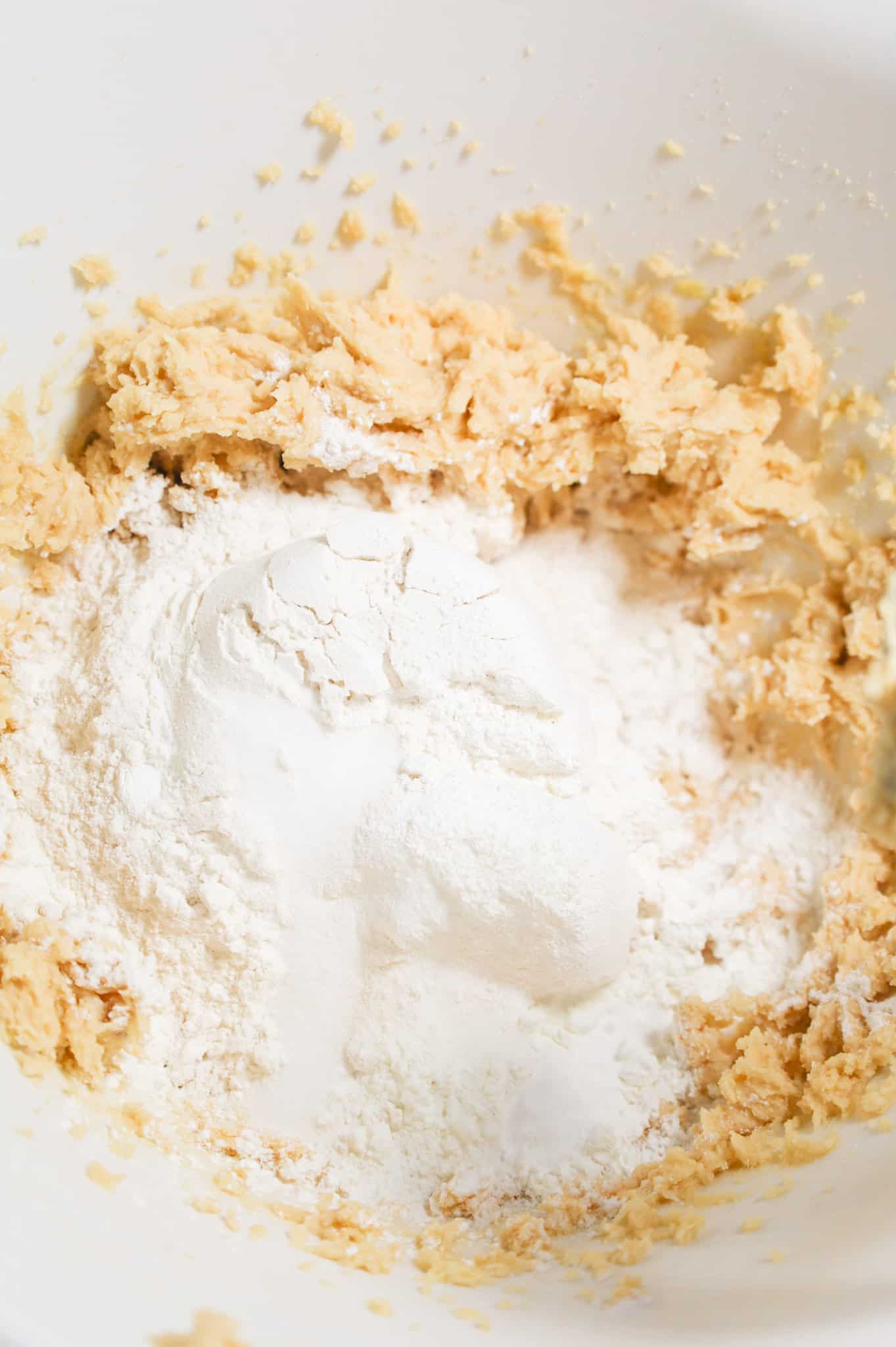 salt, baking soda, cornstarch and flour on top of butter and sugar mixture in a mixing bowl