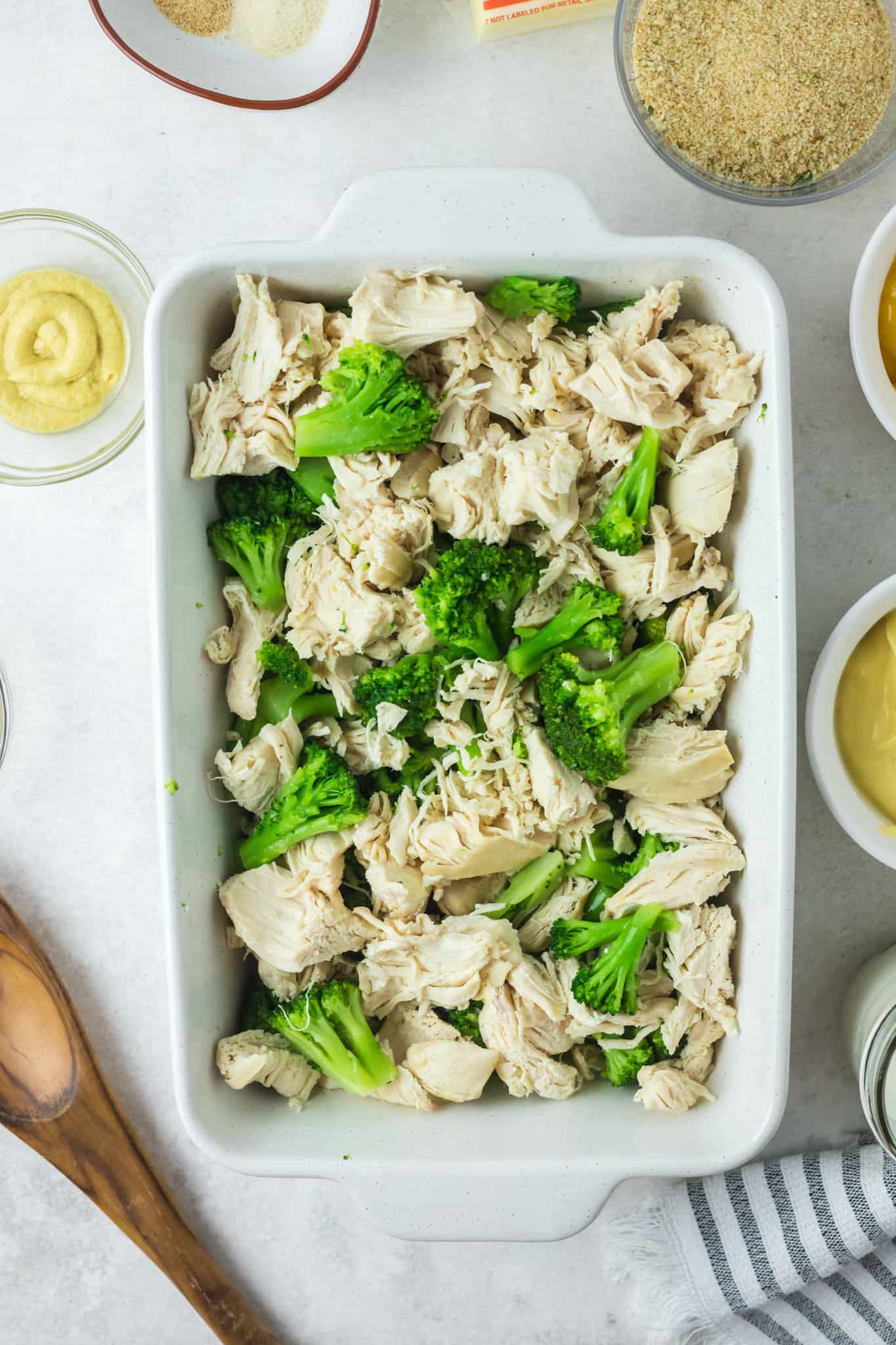 chopped chicken and broccoli florets in a baking dish