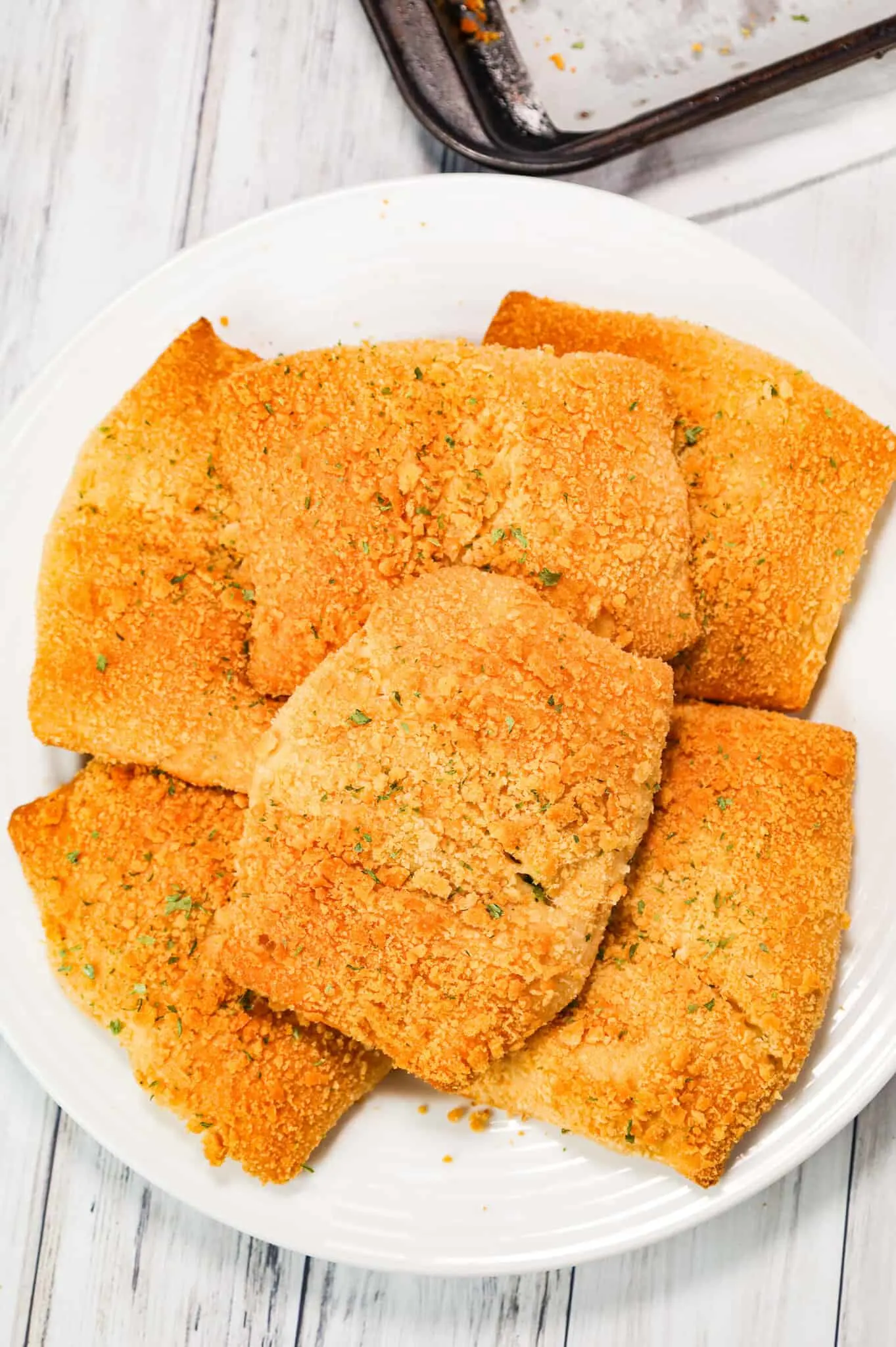 Chicken Pillows are an easy dinner recipe using rotisserie chicken mixed with cream cheese, mayo, Italian seasoning, shredded cheese and green onions all baked inside Pillsbury crescent dough topped with buttery Ritz crumbs.
