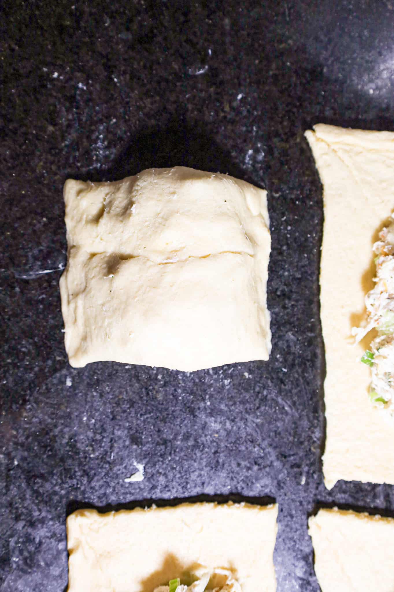 crescent dough folded over chicken mixture to form a pocket