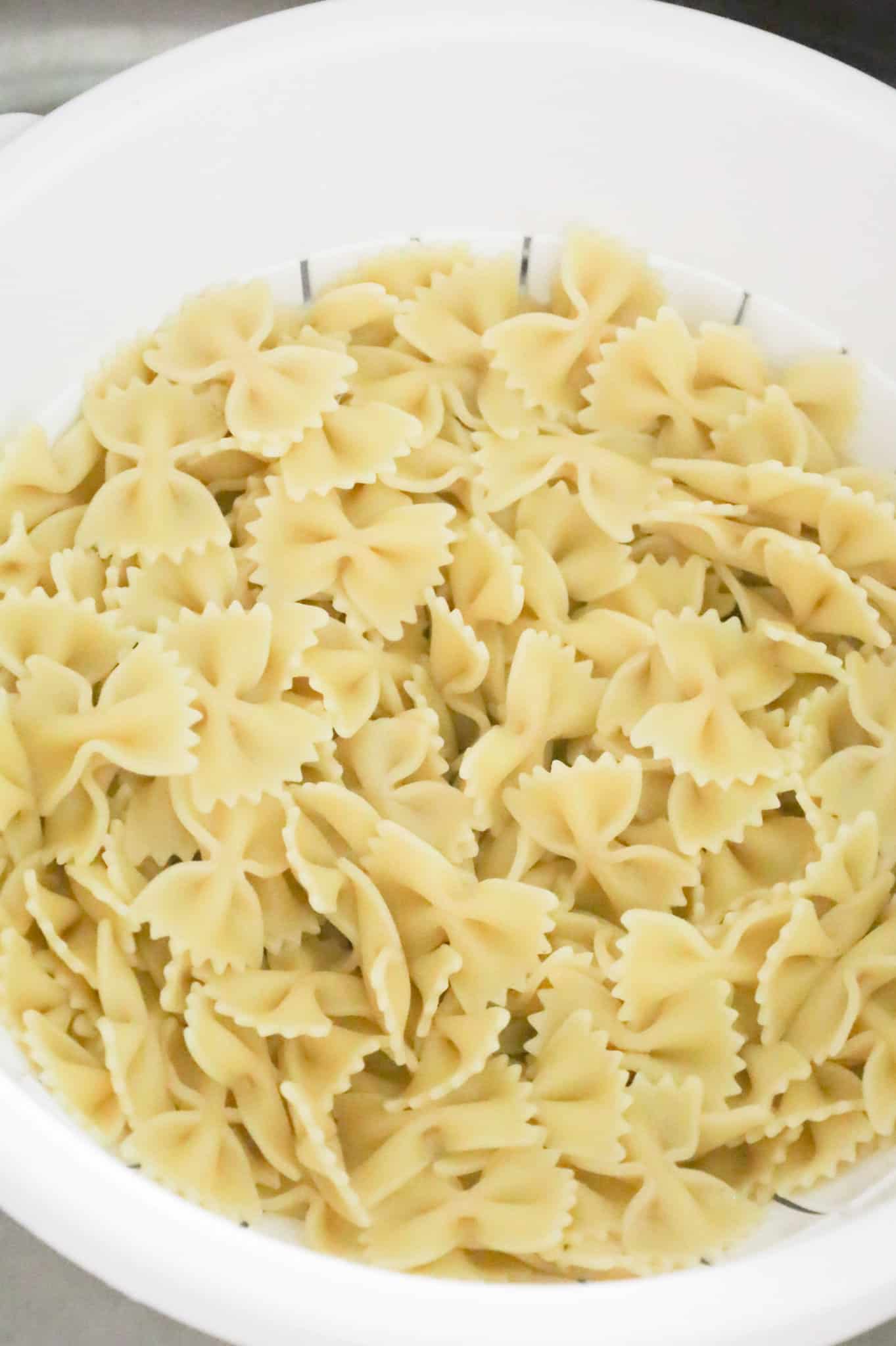 cooked bowtie noodles in a colander