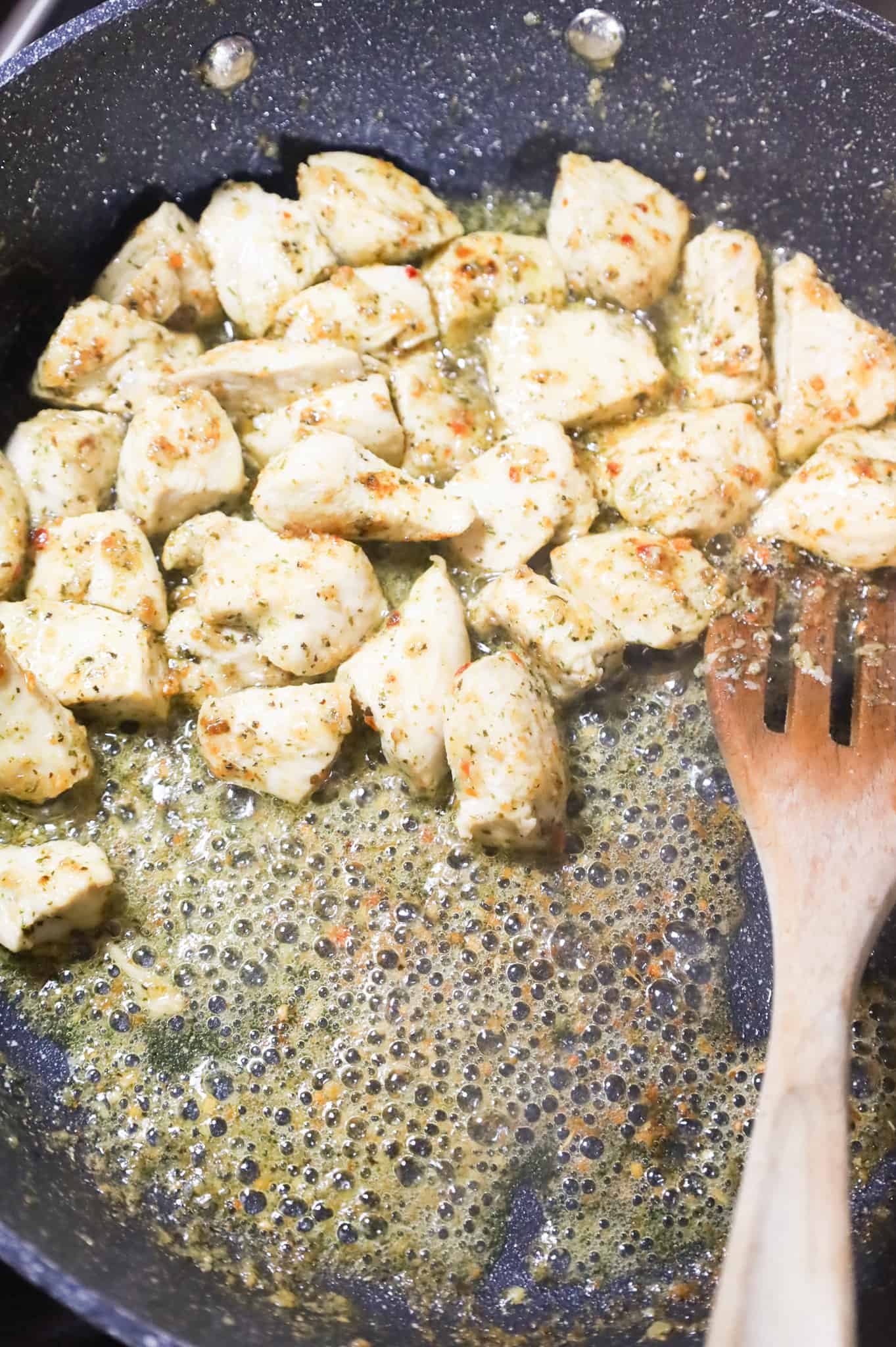 chicken breast chunks cooking until browned in a skillet