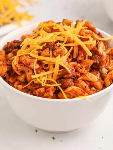 Crock Pot Goulash is an easy slow cooker ground beef and macaroni recipe with a tomato sauce and topped with cheddar cheese.