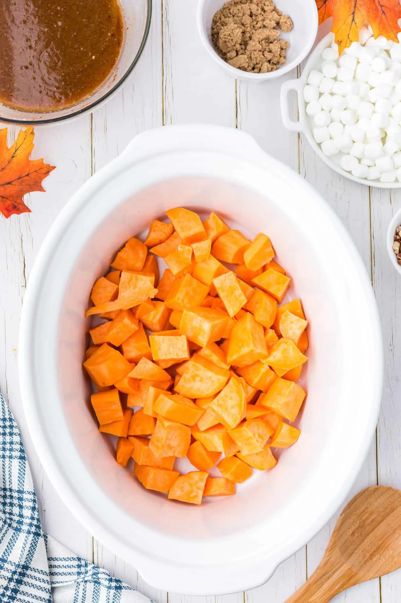 cubed sweet potatoes in the bottom of a crock pot