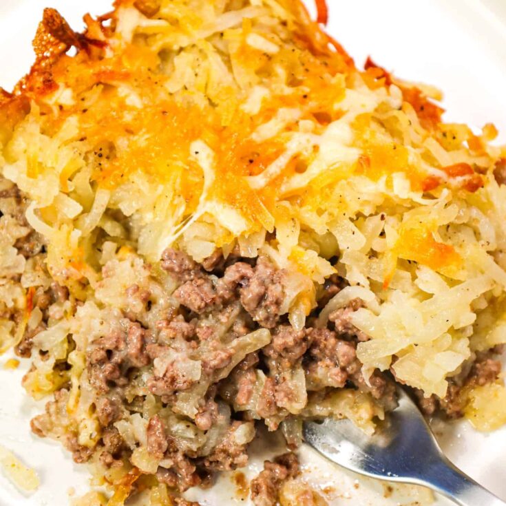 Hamburger Hashbrown Casserole is an easy ground beef dinner recipe loaded with shredded hashbrown potatoes, cream of mushroom soup and shredded mozzarella and cheddar cheese.