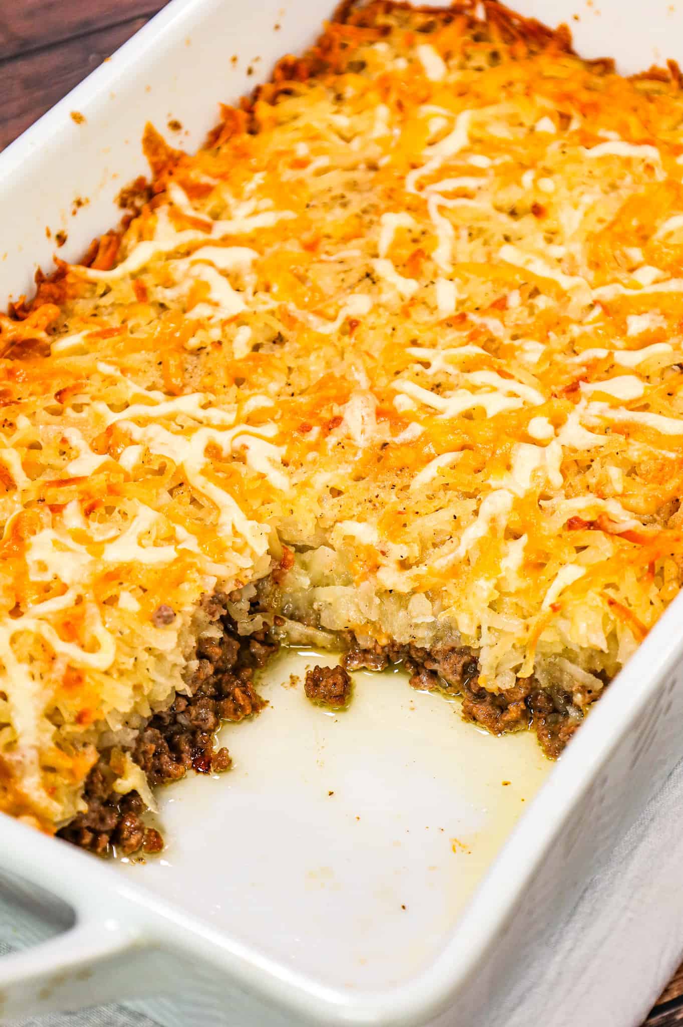 Hamburger Hashbrown Casserole is an easy ground beef dinner recipe loaded with shredded hashbrown potatoes, cream of mushroom soup and shredded mozzarella and cheddar cheese.