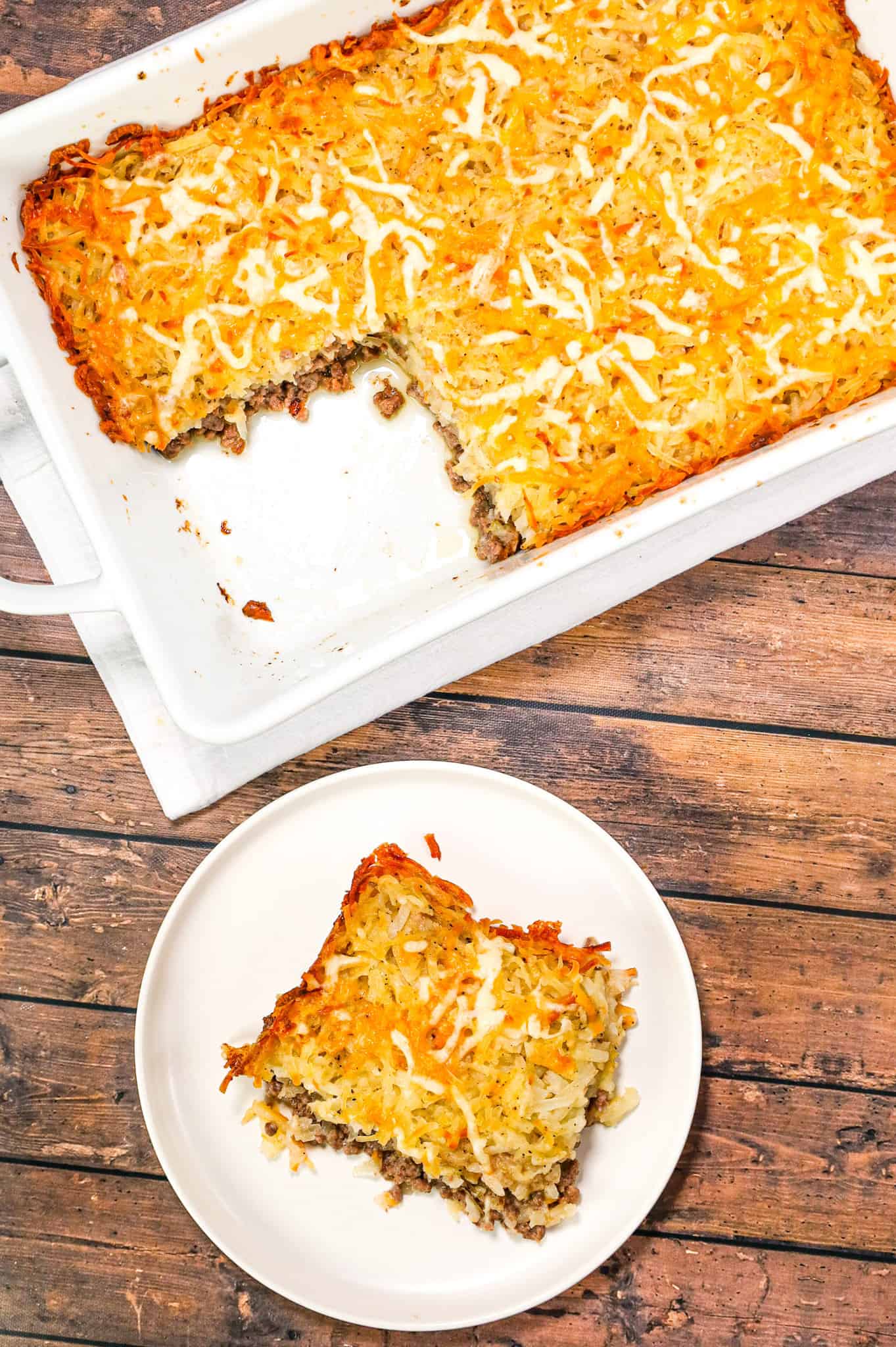 Hamburger Hashbrown Casserole is an easy ground beef dinner recipe loaded with shredded hashbrown potatoes, cream of mushroom soup and shredded mozzarella and cheddar cheese.