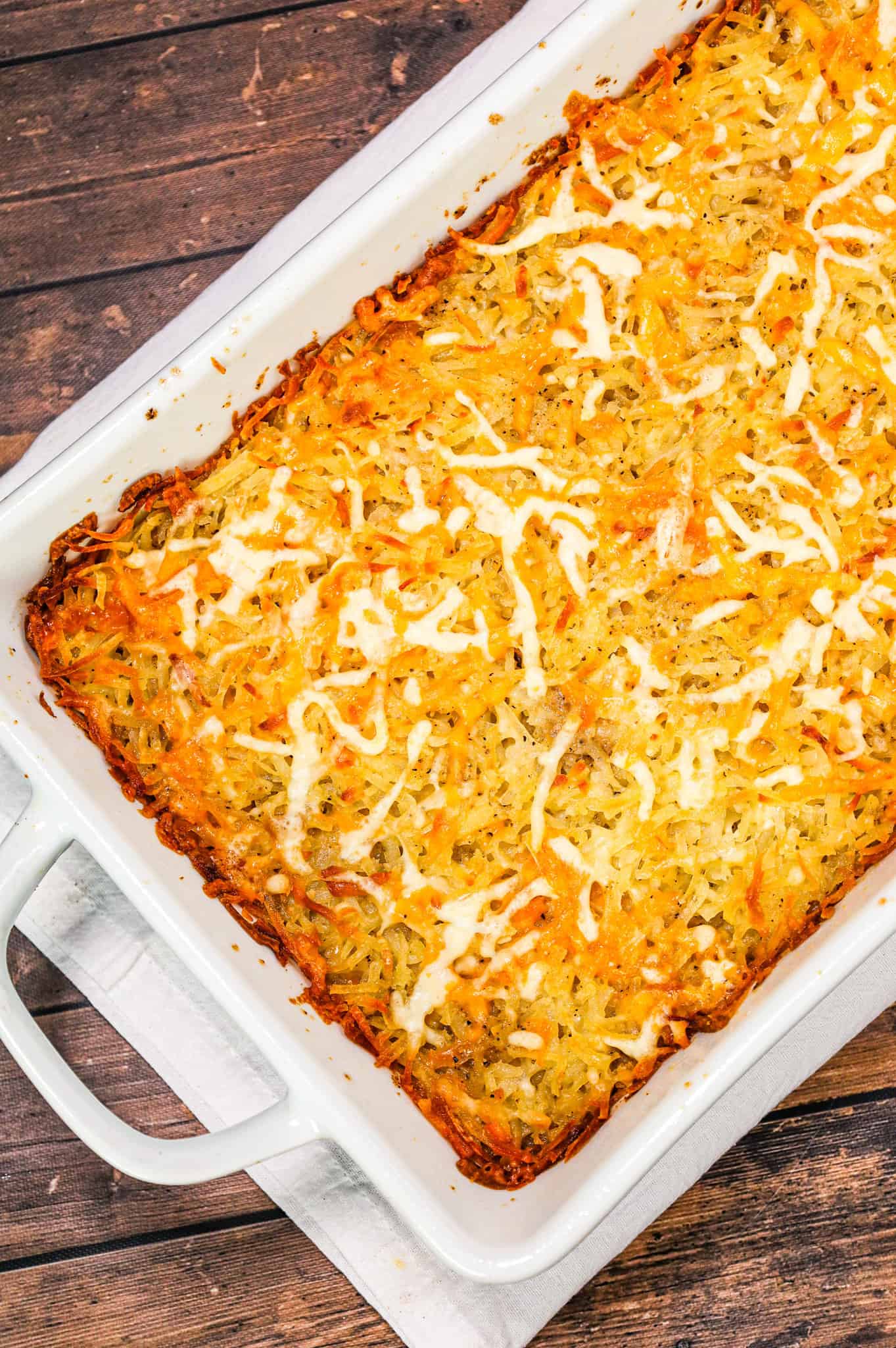 Hamburger Hashbrown Casserole is an easy ground beef dinner recipe loaded with shredded hashbrown potatoes, cream of mushroom soup and shredded mozzarella and cheddar cheese.