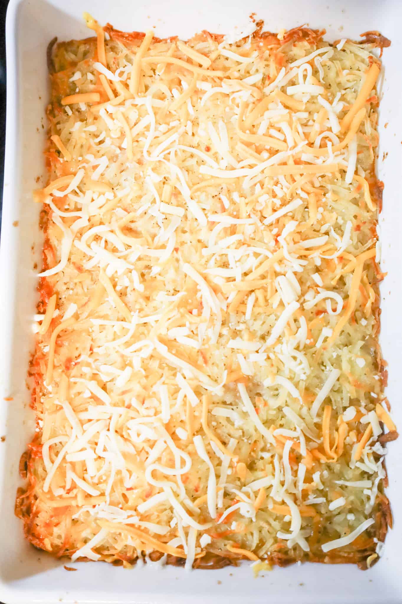 shredded cheese on top of hamburger hashbrown casserole