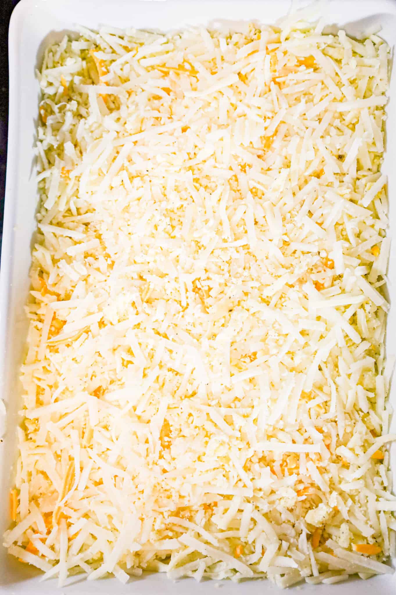 shredded potato hashbrowns in a casserole dish