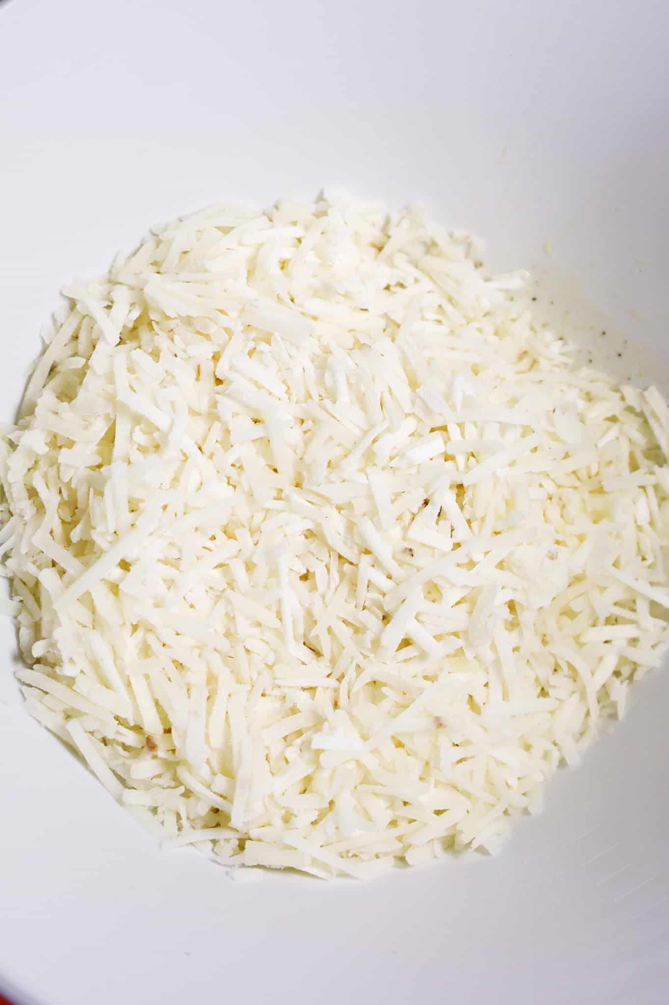 shredded hashbrown potatoes in a mixing bowl