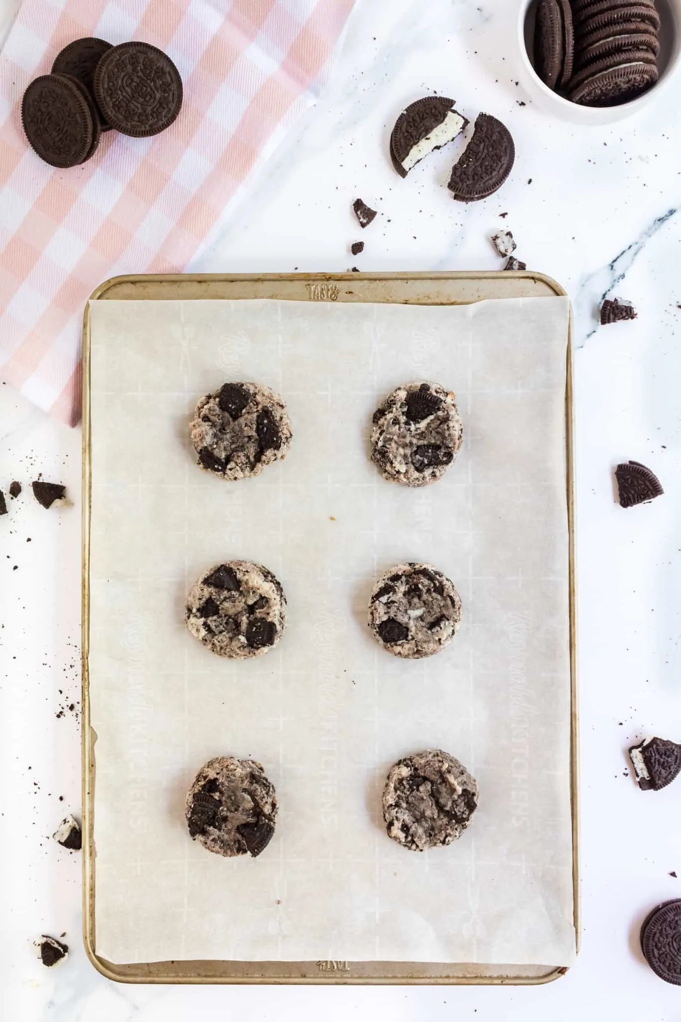oreo cheesecake cookies on a parchment lined baking sheet