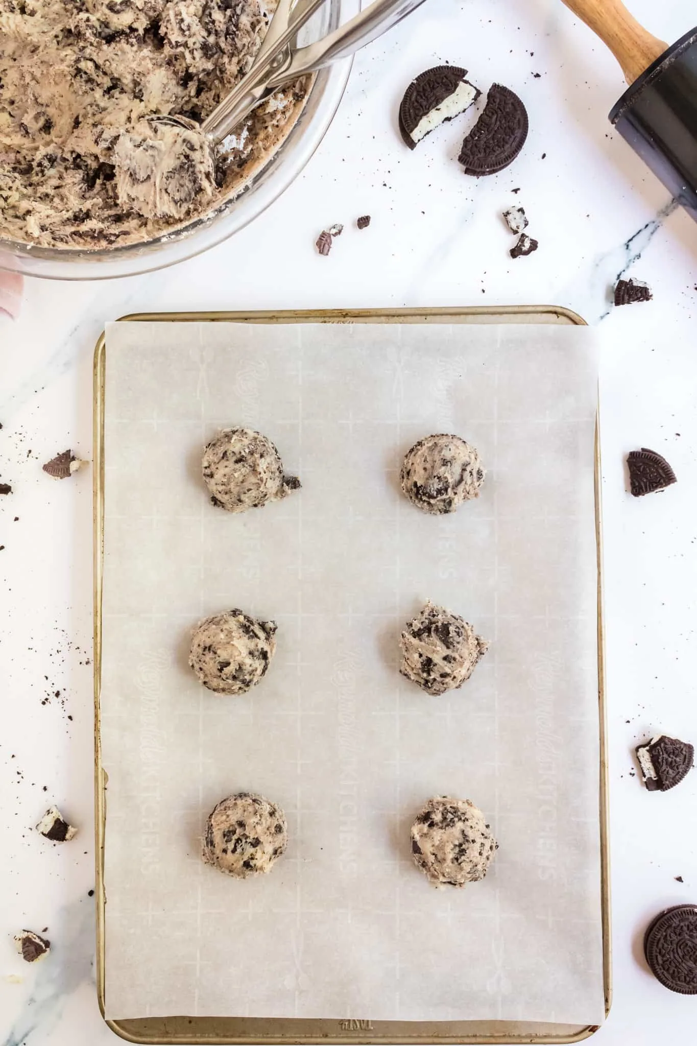Oreo cheesecake cookie dough balls on a baking sheet